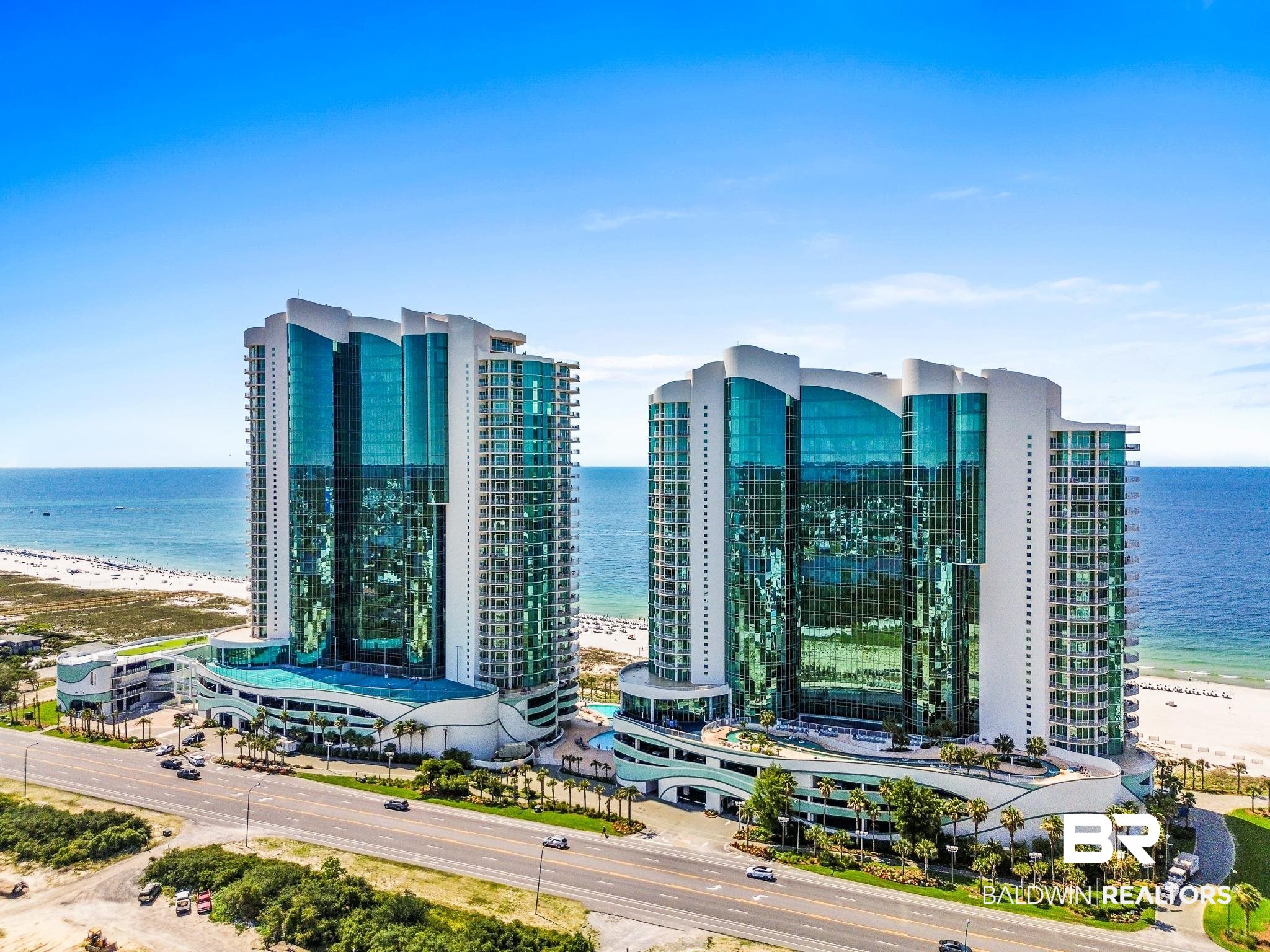 Perfectly situated in the most luxurious condominium complex in Orange Beach, AL, Turquoise Place D1609 is a west corner unit offering panoramic and unobstructed views of the Gulf of Mexico and Cotton Bayou! Upon entering this impeccable non-rental condo, you are greeted by ten-foot ceilings, curved wall architectural accents adorned with elegant faux paint, and an overwhelming sense of splendor. As your feet glide over the twenty-four-inch tile floors and make their way to the gourmet kitchen, you are immersed in an abundance of natural light and Gulf views flowing in from the floor to ceiling impact windows that line the southern and western exposures. The kitchen features granite countertops, ceiling height custom cabinets, a large island and bar with seating for eight, a 36-inch Sub-Zero refrigerator and freezer, three dishwashers, and a Wolf oven, microwave, warming drawer, and five-burner built-in gas range. The kitchen effortlessly flows into the spacious dining and living areas, which are accented by a wet-bar creating the ideal waterfront space to entertain family and friends. The Gulf front master suite boasts stunning views, direct balcony access, and a bathroom outfitted with a large tiled walk-in shower, a spacious jetted tub, private water closet, a massive custom walk-in closet, and an over-sized double vanity complete with a sitting/makeup area. The condo also offers views of Cotton Bayou from all three guest suites, views of Perdido Pass, custom electric window treatments, a gas fireplace, eight-foot solid panel wood doors, and two impressive balconies, one of which is equipped with a built-in stainless gas grill. Turquoise Place has one of the finest amenity packages along the Alabama Coast including indoor pools, outdoor pools, a lazy river, a four-story twisting waterslide, amphitheater, putting green, hot tubs, dry saunas, steam rooms, fitness centers, tennis courts, and a full-service food and beverage bar. Rental projection up to $225K! Buyer