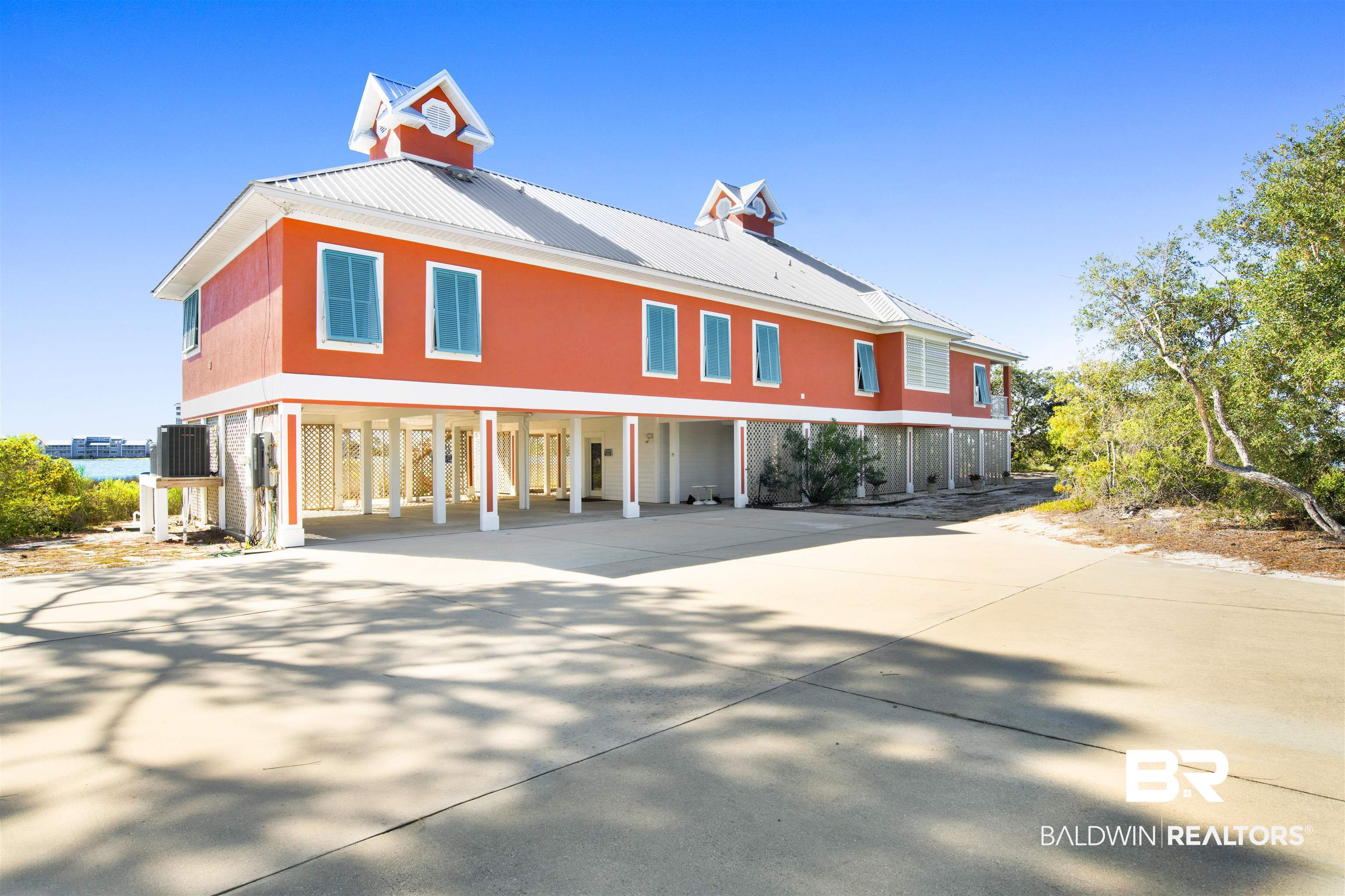 Welcome to Katie's Cove, one of the most extraordinary properties on the Gulf Coast. Set on almost 3 ACRES of private waterfront along Ono Island's coveted coastline, this secluded resort home is thoughtfully designed to embrace its breathtaking surroundings of Old River and the Gulf. This one-owner custom built residence features 1500 FEET WATER FRONTAGE, impact glass windows, electric hurricane shutters, fortified metal roof, ELEVATOR with a layout that seamlessly emerges indoor and outdoor living with attached private guest quarters overlooking Old River. Owner had pick of the lots when the island was originally developed; this property is like none other. A unique island on an island.   Buyer to verify all information during due diligence.