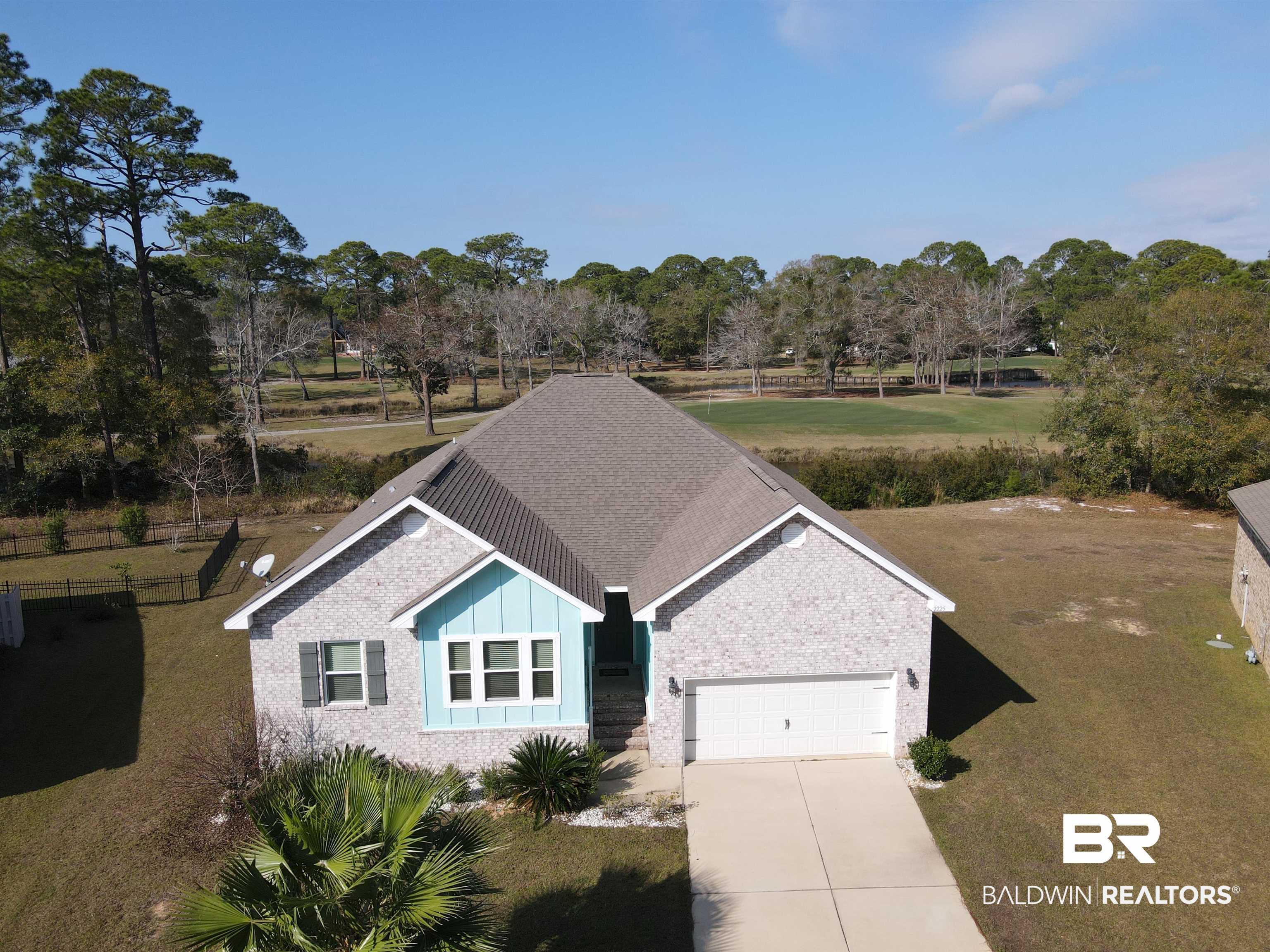 Welcome to this beautifully crafted Gold Fortified home built in 2019, tucked away in the quiet Islandwood neighborhood on the island in Gulf Shores. Backing directly onto the Gulf Shores Golf Course, this property offers peaceful views of manicured fairways and a serene pond. This 4-bedroom, 2-bath home features a split floor plan designed for privacy and functionality. The spacious owner’s suite is set apart and includes 10-foot tray ceilings, a spa-like bath with garden tub, separate tiled shower, dual vanities, private water closet, and a large walk-in closet. Additional bedrooms are thoughtfully positioned, offering flexibility for guests or family. The open-concept kitchen, living, and dining area is filled with natural light and features 11-foot tray ceilings, stainless steel appliances, granite countertops, a large island, and a generous pantry. Granite continues throughout the bathrooms, and 9-foot ceilings enhance the sense of space. Enjoy the convenience of being just 2 miles from the beach and only 2 miles from the Bodenhamer Recreation Center, offering an indoor heated pool, fitness center, indoor track, racquetball courts, tennis center, and a variety of fitness classes with flexible membership options. Located in the Gulf Shores School District, this home offers a perfect blend of comfort, location, and coastal lifestyle.