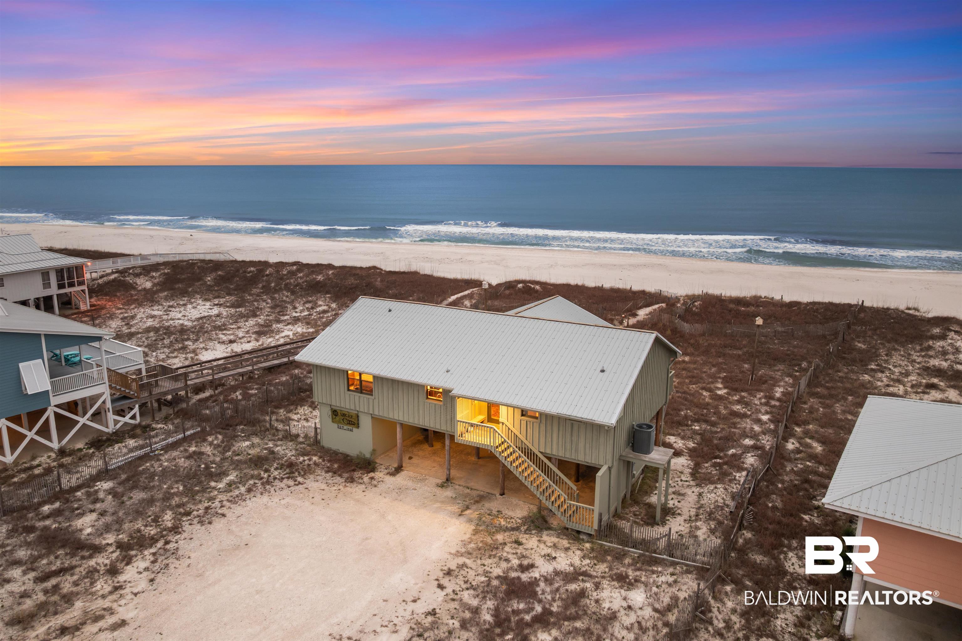 This is the only Gulf-front lot currently available on West Beach offering a true 100’ x 342’ footprint, set along 100 feet of pristine, sugar-white Gulf-front shoreline. This iconic West Beach cottage has never been on any rental program and presents a rare opportunity to own a piece of coastal history. With $140,000 yearly rental projection it is tucked behind sweeping natural sand dunes on over three-quarters of an acre, the property offers exceptional privacy while preserving breathtaking beachfront views. Lovingly maintained as a personal residence and never rented or placed in a rental program, the home is in excellent condition and reflects years of thoughtful care and pride of ownership.Designed to embrace the simple luxury of coastal living, the home welcomes you with an effortless sense of warmth and relaxation. After a day on the beach or in the Gulf, an outdoor shower provides the perfect transition before stepping inside to a sun-filled, open-concept living space highlighted by a striking vaulted wood ceiling that captures the charm and character of classic seaside cottages. The kitchen blends beauty and function with solid wood cabinetry, tile countertops and backsplash, stainless steel appliances, and a generous island with seating for seven, ideal for entertaining after long days by the water. Two bedrooms, including the primary suite, feature direct Gulf views and private balcony access, offering a seamless connection to the surrounding coastal landscape. The living spaces flow effortlessly outdoors onto a full-width Gulf-front porch, complete with built-in benches, a hanging swing, and an expansive screened-in porch overlooking the Gulf, creating the perfect setting for morning coffee, sunset cocktails, and the soothing sound of waves. This is more than a home, it is a rare Gulf-front legacy property. Buyer to verify all information during due diligence.