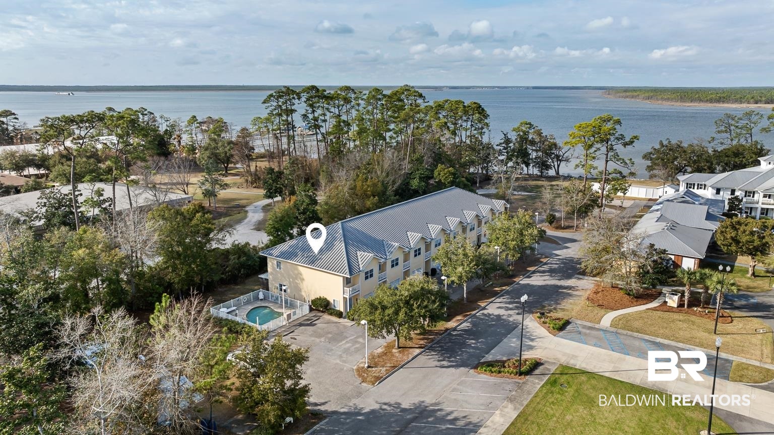 Tucked away in the community center of Orange Beach, Nancy Lane #8 offers the perfect blend of coastal charm, local recreation, and everyday convenience. This 3-bedroom, 2.5-bathroom corner townhome is 1,618 square feet of thoughtfully designed, easy living space with park views and lots of light, thanks to the unit's corner location. Step inside to find a bright and functional residence where natural light pours through the extra windows, accentuating the clean finishes and roomy floor plan. The stocked kitchen is appointed with ample cabinets, granite countertops, and black/stainless appliances, perfect for preparing a meal after a day on the water. A newly updated half-bath on the main level adds convenience. Upstairs, the primary suite offers a peaceful retreat with large windows and a bath with a walk-in closet, jetted tub, and separate shower. Two additional bedrooms provide flexibility, ideal for use as a home office, studio, or guest accommodations. The home is being sold fully furnished with all appliances, coastal decor, household items and kitchen supplies, and all linens included! Recent updates include new 2-inch blinds in the bedrooms, fresh paint, new shower heads, new light fixtures, new ceiling fans, and a new vanity with sink and lighting in the half bathroom. Step outside to your covered patio, where you'll be greeted by views of Wolf Bay to the north. Parking is never a hassle with a 1-car garage and assigned parking right in front of the home. Beyond the residence itself, the amenities and golf-cart-friendly location are unbeatable. Nancy Lane residents can dip in the community pool or head next door to the Orange Beach Waterfront Park and Pier, Kids Park, the Coastal Arts Center (site of the annual OB Art Festival), and the Wind and Water Learning Center. The Library, Senior Center, GT’s Restaurant, and the OB Recreation Center are moments away. On Nancy Lane, you’re never far from the best that Orange Beach has to offer. Come see for yourself!