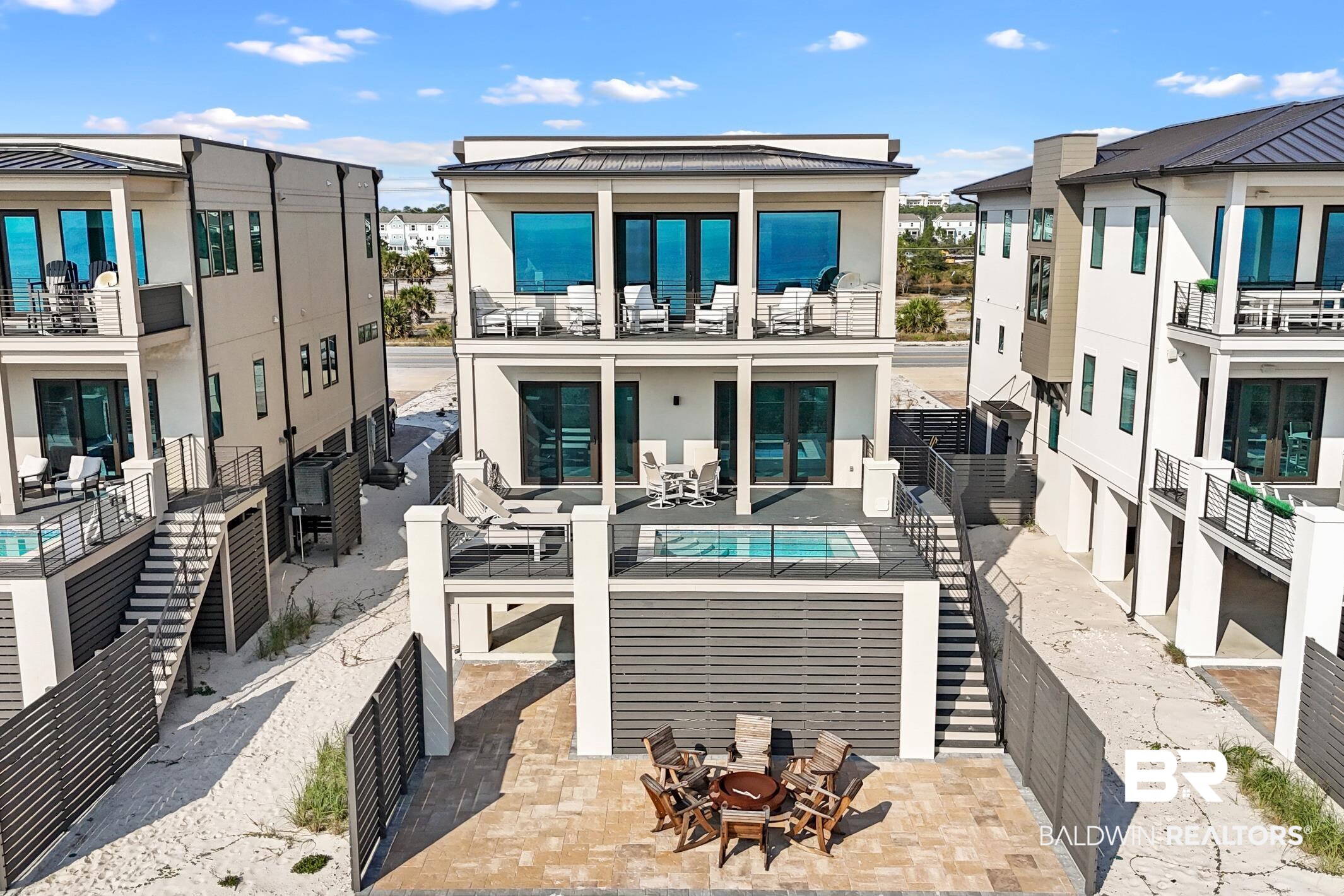 Experience coastal living at its finest in this exceptional 5-bedroom, 5.5-bathroom Gulf-front residence, perfectly positioned to capture sweeping water views and unforgettable sunsets. Designed for those who value both elegance and comfort, this home showcases thoughtful craftsmanship, including crown molding throughout and beautifully appointed living spaces ideal for relaxation or entertaining. Step outside to your private coastal oasis—an area created to savor every Gulf breeze. Enjoy: a sparkling in deck pool with a heater AND A CHILLER for those hot summer days; A built-in gas grill; A spacious ground-level patio perfect for a fire pit gatherings and starry nights. This is outdoor living the way it was meant to be. Every detail has been planned with convenience in mind: Three-car garage; Elevator to all three levels; A well-appointed kitchen designed for entertaining and family living. Two master suites - a Gulf-front suite with immediate beach access, plus an expansive private suite on the third floor. 4 of 5 bedrooms feature en-suite baths, creating ideal accommodations for guests or multi family situation. In under 6 months on a rental program, it has generated $150,000   in rental income, with 2026 looking great too. Home is mostly furnished, with certain items excluded. Buyer to verify and satisfy themselves with all information, including but not limited to measurements and square footage. Information is deemed reliable but not guaranteed. Buyer to verify all information during due diligence.