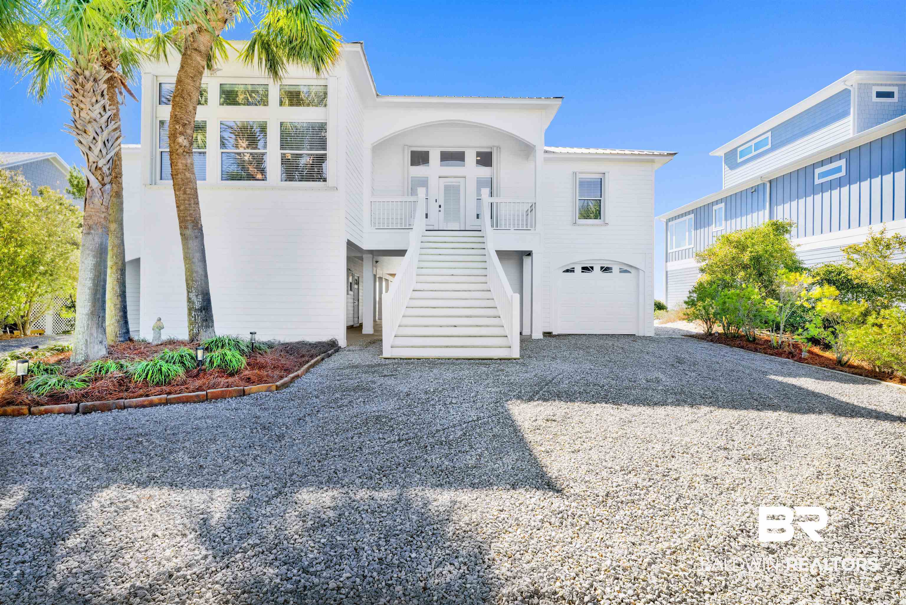 A once-in-a-lifetime opportunity to own one of Alabama's prime Gulf Coast waterfront properties. Accessible by boat or car, this one-owner custom-built well elevated residence is located on highly sought-after Ono Island overlooking Old River and Perdido Key State Park. Property offers a front row seat to nature: dolphins playing,  herons gliding overhead, pelicans diving at sunrise and ospreys soaring above your shoreline. Home features a new covered boathouse, hurricane shutters, ELEVATOR, office, bonus room that would make a nice bunk room or studio, a huge workshop/tackle room, nice garage and carports with plenty of room downstairs to expand to suit your lifestyle. Covered waterfront porches open to a high ceiling interior with waterfront open living/dining/kitchen areas. The kitchen has excellent space and a nice wet bar, cabinetry, pretty granite and stainless appliances. The primary suite opens directly to waterfront views and features a large walk-in closet, dual vanities, tub and separate shower. This open layout is perfect for gathering or as a private coastal retreat. Conveniently located approximately 30 minutes from the Gulf Shores International Airport. This one is a keeper!  Buyer to verify all information during due diligence.