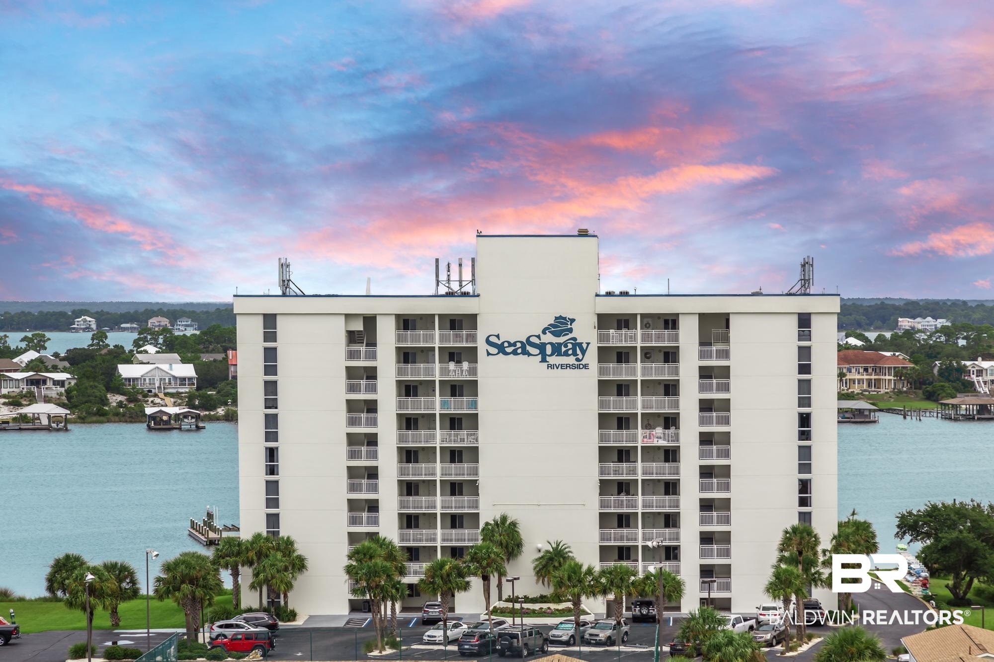 RARE OPPORTUNITY TO OWN THIS 8TH FLOOR EAST CORNER RESIDENCE AT SEASPRAY RIVERSIDE WITH SWEEPING WRAP-AROUND BALCONY AND BREATHTAKING, PANORAMIC VIEWS OVERLOOKING OLE RIVER, ONO ISLAND, PERDIDO BAY AND THE GULF! ENJOY THE BEST OF BEACH AND BOATING IN THIS MOVE-IN READY 3BR/3BA RESIDENCE WITH EASY BEACH ACCESS DIRECTLY ACROSS THE STREET PLUS FULL BOATING FACILITIES (SLIPS, LAUNCH AND SECURE STORAGE) ON THE DEEP WATERS OF OLE RIVER. Beautifully updated and FURNISHED, this gem offers one of the best condo floor plans in the area with floor-to-ceiling glass spanning the width of the living and dining areas (which are open to the kitchen) so you can enjoy gorgeous water views and boats passing by without ever leaving your condo! Featuring a lovely open floor plan, completely remodeled kitchen, spacious island, quality cabinetry, stainless appliances, and gorgeous granite countertops. The condo features low-maintenance tile flooring throughout. The primary bedroom features an en-suite bath with double vanity, oversized tiled shower, large walk-in closet plus an extra closet so you can create a locked owner storage area. The water heater has also recently been replaced. Seaspray owners and guests enjoy plenty of great amenities…three swimming pools (1 Riverside and 2 Gulfside - one zero entry), hot tub, fitness center with beautiful Gulf views, community room, lighted tennis/pickleball courts, kayak/paddleboard racks and large designated pet area. Strong HOA with on-site management and dedicated maintenance staff. Seaspray was completely reconstructed in 2006 with special features like paperless dry wall, so the community has an effective ‘year built’ of 2006 with the county property appraiser. RELAX AND WELCOME HOME TO LAID-BACK ISLAND LIFE! Buyer to verify all information during due diligence.