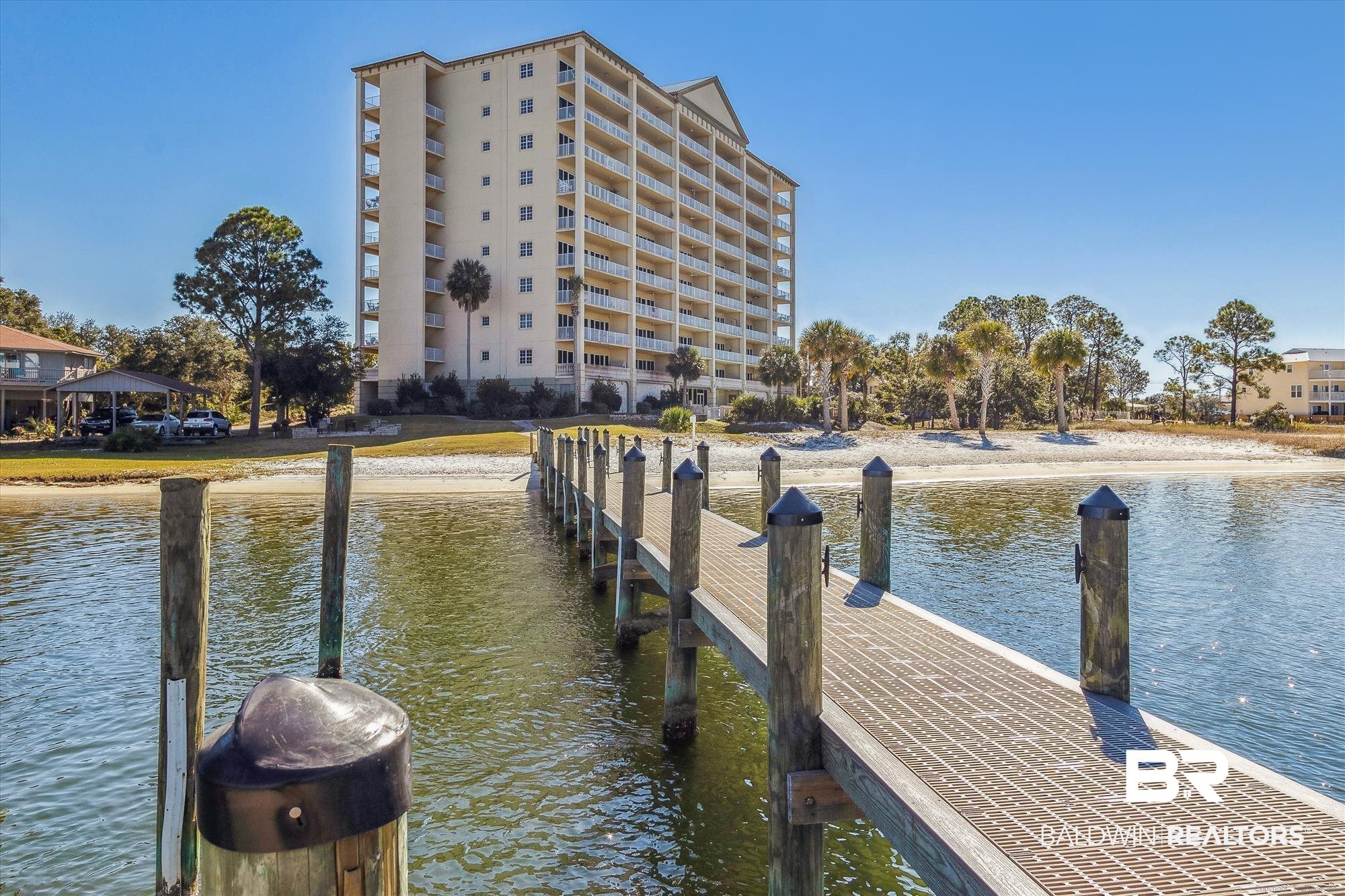 Experience breathtaking views of the Intracoastal Waterway, Old River, and the Gulf of Mexico from this exceptional 5-bedroom, 5.5-bathroom condo in Perdido Key. Spanning two stories and over 3,100 square feet, this waterfront residence offers a rare combination of both sunrise and sunset vistas, with two north-facing balconies overlooking the Intracoastal Waterway and a south-facing balcony capturing Gulf views. It's two-story design provides private entrances on both the 9th and 10th floors. This spacious coastal retreat features an open-concept upper level with a large kitchen, dining area, and living space ideal for entertaining. The primary suite includes a private bath with garden tub, separate shower, and dual vanities. You'll also enjoy a bar/entertainment room, half bath, and laundry on this level. The lower floor provides four generously sized bedrooms, with its full baths, along with a second laundry area. Elegant tile and wood-look vinyl flooring flow throughout the residence, complemented by large windows that brighten the space with natural light. The kitchen is outfitted with stainless steel appliances and expansive counters, creating a perfect blend of function and style. Located in Sailmaker’s Place, the property includes access to premium amenities such as a zero-entry pool, fitness center, theater room, BBQ area, boat dock, and a private Intracoastal BEACH. Love to fish? You have found your fishing haven at the super fishing spot! Don’t miss your chance to tour this unique waterfront property—schedule your showing today! Buyer to verify all information during due diligence.