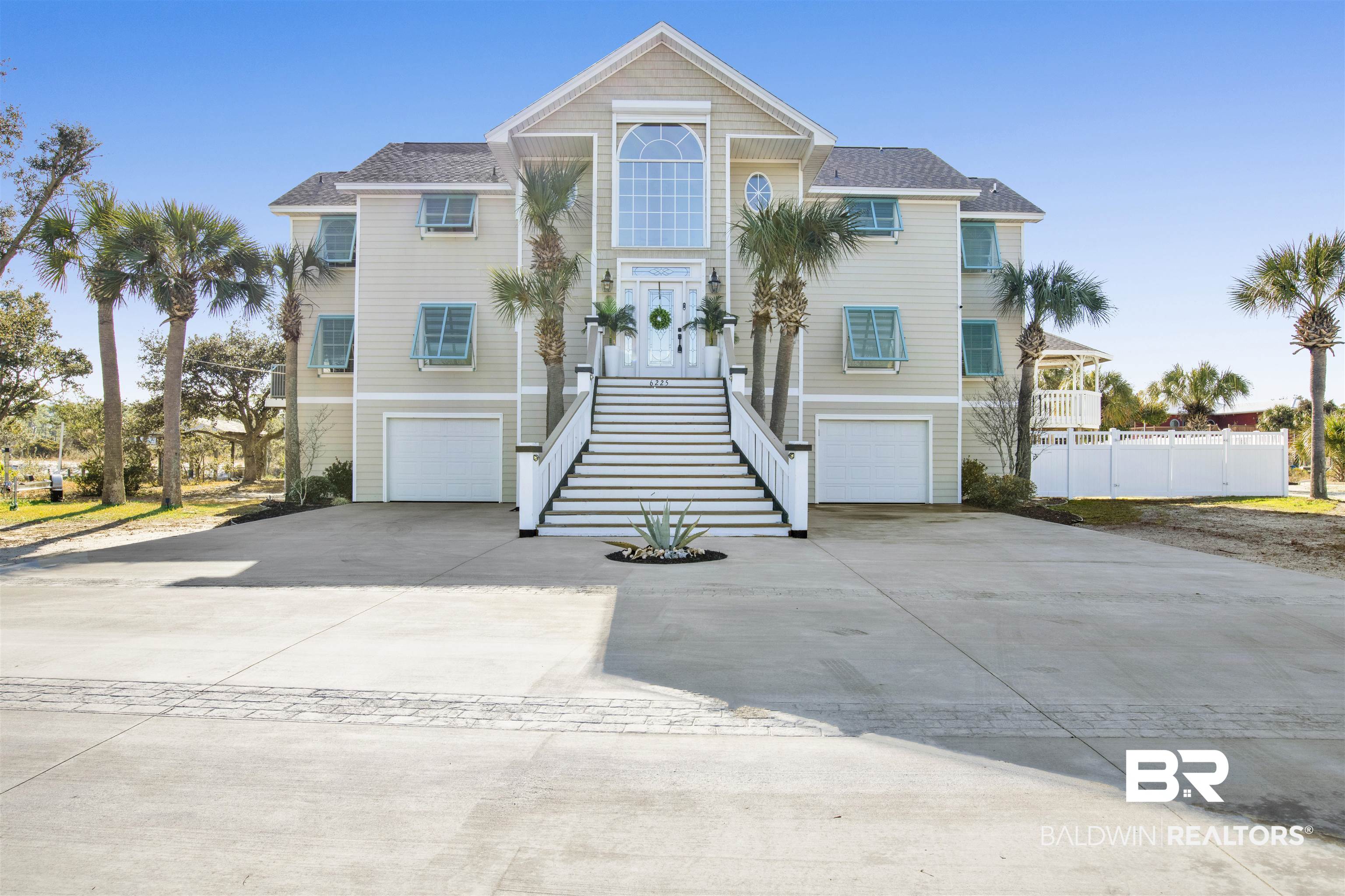 BACK ON MARKET due to no fault of house or seller. Bring all offers! Welcome to true island living! Enjoy dolphins & manatees from your dock on 134ft of canal with quick ICW access. Boathouse with electric lift & remote. This stunning 4-bed, 6-bath beach-style home has a smart reverse floor plan to create WOWZA views from a huge Palladian window where you can watch weekend boat parades and Blue Angels practice. Out back enjoy full lanai and porches, and custom pavers create huge entertaining space with TV, shower, cabana bath. NEW gunite pebble-tec self-cleaning, salt POOL w/ waterfalls, remote LEDs, heater/chiller. Convenient LIFT serves all floors. Middle floor has new ensuite walk-in shower w/bedroom that opens to kitchenette, sitting room and private porch access. This floor also has family room, powder bath and 2 bedrooms with Jack & Jill. Top level is primary living with awe inspiring views, vaulted ceilings, high-end kitchen with gas cooktop, and island that seats 10. Custom bar with live edge is an entertainer's dream (bar furniture conveys). Hidden flex room is a favorite for an office, pantry or speak-easy! Large primary en-suite bedroom with porch access, fireplace, huge walk-in closet and bath featuring walk-in shower with dual heads, and center LED waterfall. New hurricane storm coverings including remote-controlled metal shutter for front Palladian window. Additional fortification throughout house include new boathouse, gazebo and house roofs, gas lines, both A/C units, insulation, electrical, Everlast triple composite lifetime siding etc. Brand New this February, a 3,000 sqft custom brick stamped driveway! Buyer to verify all information during due diligence.