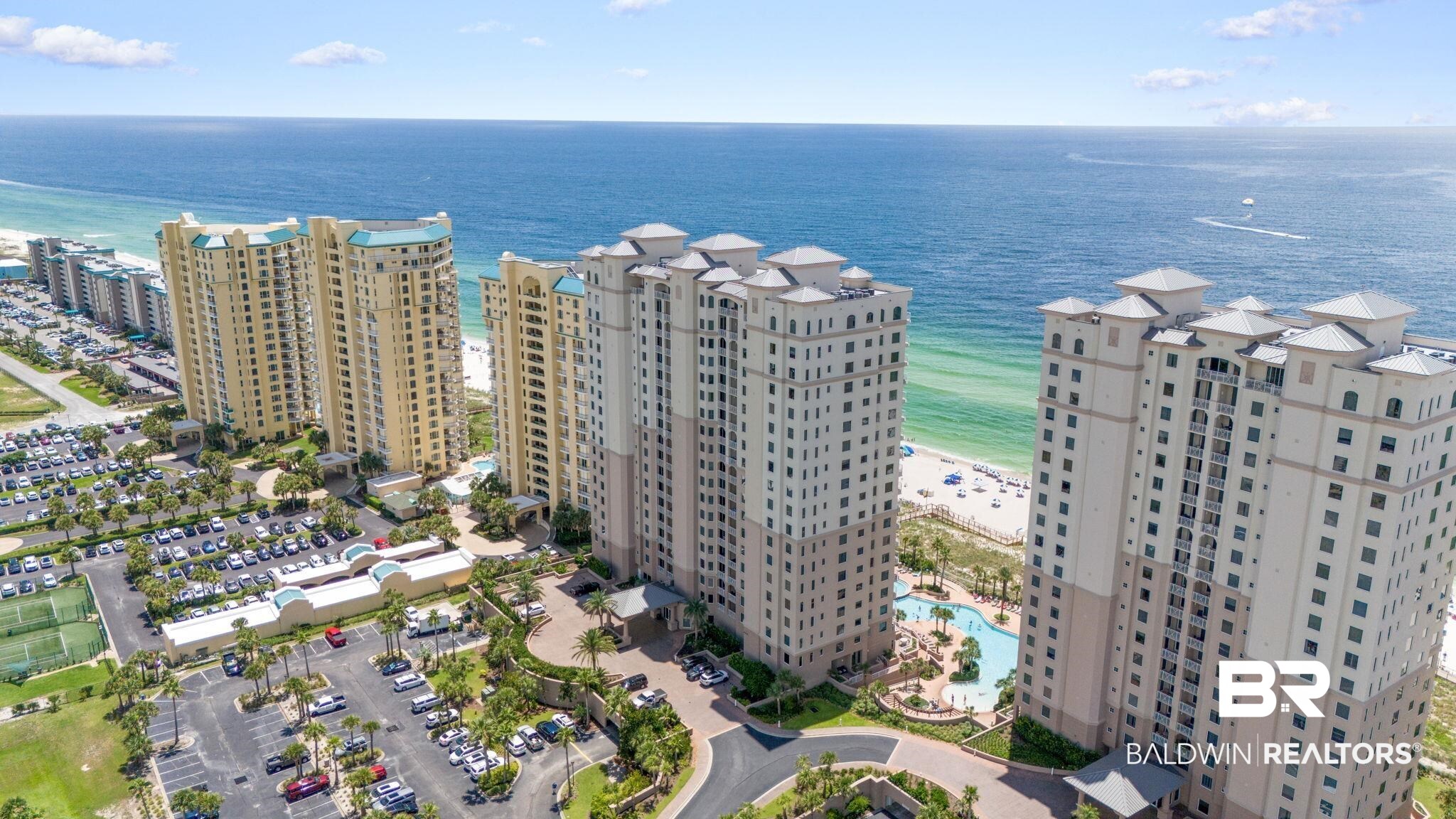 Opportunity awaits to own a lovingly maintained & beautifully furnished, never-rented residence in Perdido Key's premier gated, beachfront resort community of Indigo - A great investment or getaway! This Gulf front condo welcomes you with a private elevator entry foyer, leading into a spacious 2-bedroom, 2.5-bath layout. Step inside & onto the tile floors that will lead you through the living areas & primary bedroom. Enjoy breathtaking Gulf views from the master suite, which has a large, picturesque window, an expansive closet & direct access to the Gulf-facing balcony. The ensuite bathroom offers a large, tiled shower. The guest suite acts as a second primary suite, offering the perfect spot to relax on the suite's private north-facing terrace, offering stunning vistas of the Intracoastal & the picturesque surroundings of Perdido Key. The guest suite also has an ensuite bathroom & two closets. An in-unit washer & dryer make laundry a breeze! The kitchen is the perfect place for cooking & entertaining – boasting stainless steel appliances, a unique pocket door & easy access to your personal hallway trash chute. A 2021 HVAC & 2020 water heater offer peace of mind. Ownership benefits include an assigned storage unit in a climate-controlled area perfect for storing beach essentials & covered parking. Indigo is a secure, gated community spanning 6 acres of pristine beachfront, & this residence offers many resort-style amenities & perks. Soak up the sun on the beach or cool off with a swim in the zero-entry 6,000sf pool, which is partially heated in the winter, then unwind in the hot tub or hit the tennis/pickleball courts. Take advantage of community grilling areas equipped with Big Green Egg grills & enjoy the gazebo & beachside scenery. Recently updated amenities include a fitness center, movie theater, common area lobbies, & owner's community rooms. This condo is a prime location - close to restaurants, shopping & all fun-filled activities in Perdido Key!   Buyer to