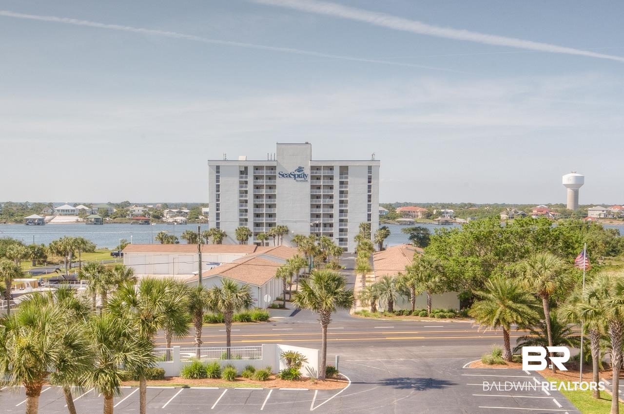 Discover breathtaking, panoramic views of Ole River, Ono Island, Perdido Key State Park, and the GULF OF MEXICO from this TOP FLOOR 3BR/3BA CORNER residence at SeaSpray Riverside. ASSIGNED GARAGE #3 IS INCLUDED!! ALSO AVAILABLE IS ASSIGNED #9 GARAGE AND/OR 2 RARE DEEP WATER BOAT SLIPS WITH LIFTS ARE AVAILABLE FOR PURCHASE SEPARATELY! This furnished residence features beautiful coastal modern style. Relax and enjoy the boats going by from your private WRAP AROUND balcony with access from the living room, dining area and Master Bedroom. The open concept kitchen with spacious island, white cabinetry, ALL NEW stainless appliances, granite countertops, and eat-in-bar is perfect for those who love to cook and entertain. The master bedroom has an en-suite bath, double vanity, shower, and large walk-in closet. All of the bedrooms have NEW wood look tile as well! SeaSpray owners and guests enjoy spectacular amenities including two gulf-front pools (one with zero entry), a riverside pool, fitness center, tennis courts, pier, docks, AND DEEDED BEACH ACCESS. SeaSpray has wonderful on-site management, rentals, and maintenance staff with an established, solid homeowners’ association with competitive HOA fees. Welcome home to laid-back island life!