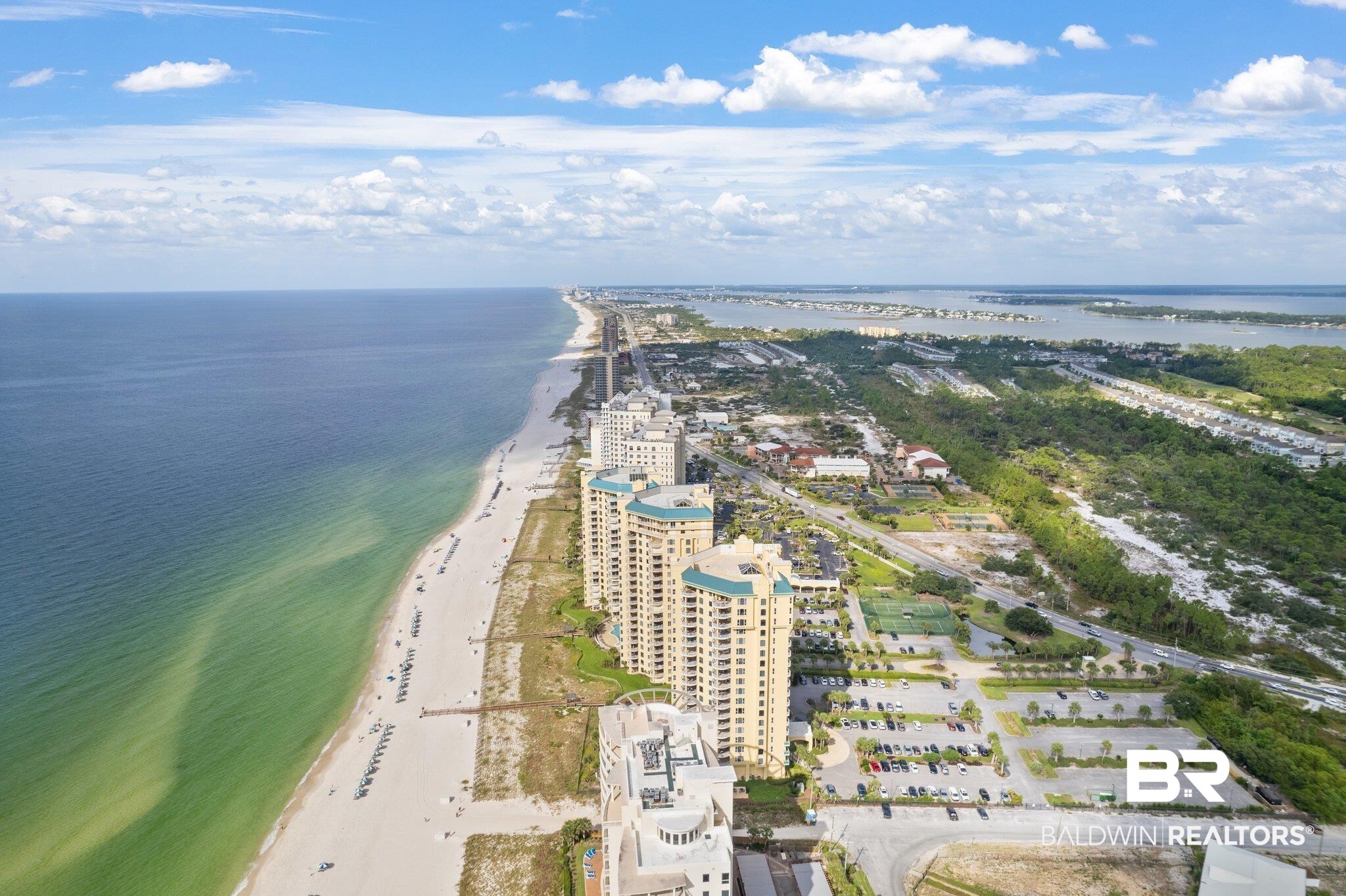 Experience stunning views of the Gulf of Mexico from this spacious 3-bedroom/3-bath fully-furnished condo at Beach Colony Tower providing year-round enjoyment. This gorgeous residence offers high-end coastal furnishings, with updated flooring and custom wood plantation shutters adding a special touch to this beach abode, while the new 2023 HVAC and 2024 water heater provides peace of mind. The kitchen has elegant countertops, an eat-in kitchen and separate pantry closet. The primary bedroom boasts breathtaking views of the Gulf of Mexico with floor to ceiling sliding glass doors, allowing seamless access to the balcony and welcoming extra light and sunshine.  The primary bathroom has double vanities, a Whirlpool tub overlooking the beach and a separate shower. The two additional bedrooms are luxury suites, ideally situated with north-facing private balconies. Just 4 units per floor, Beach Colony offers the complete resort experience and allows you to relax and unwind with 3 pools, 1 that is enclosed for year-round use, hot tub/spa, tennis courts, and fitness center.  Private beach walk overs for easy access to the beach and the sandy white beaches of Perdido Key. Extra storage outside unit. An additional perk is on-site management. Take advantage of this opportunity to have your very own beach getaway or lucrative rental investment. This is the beachfront condo that you've been waiting for - It's truly a must see!