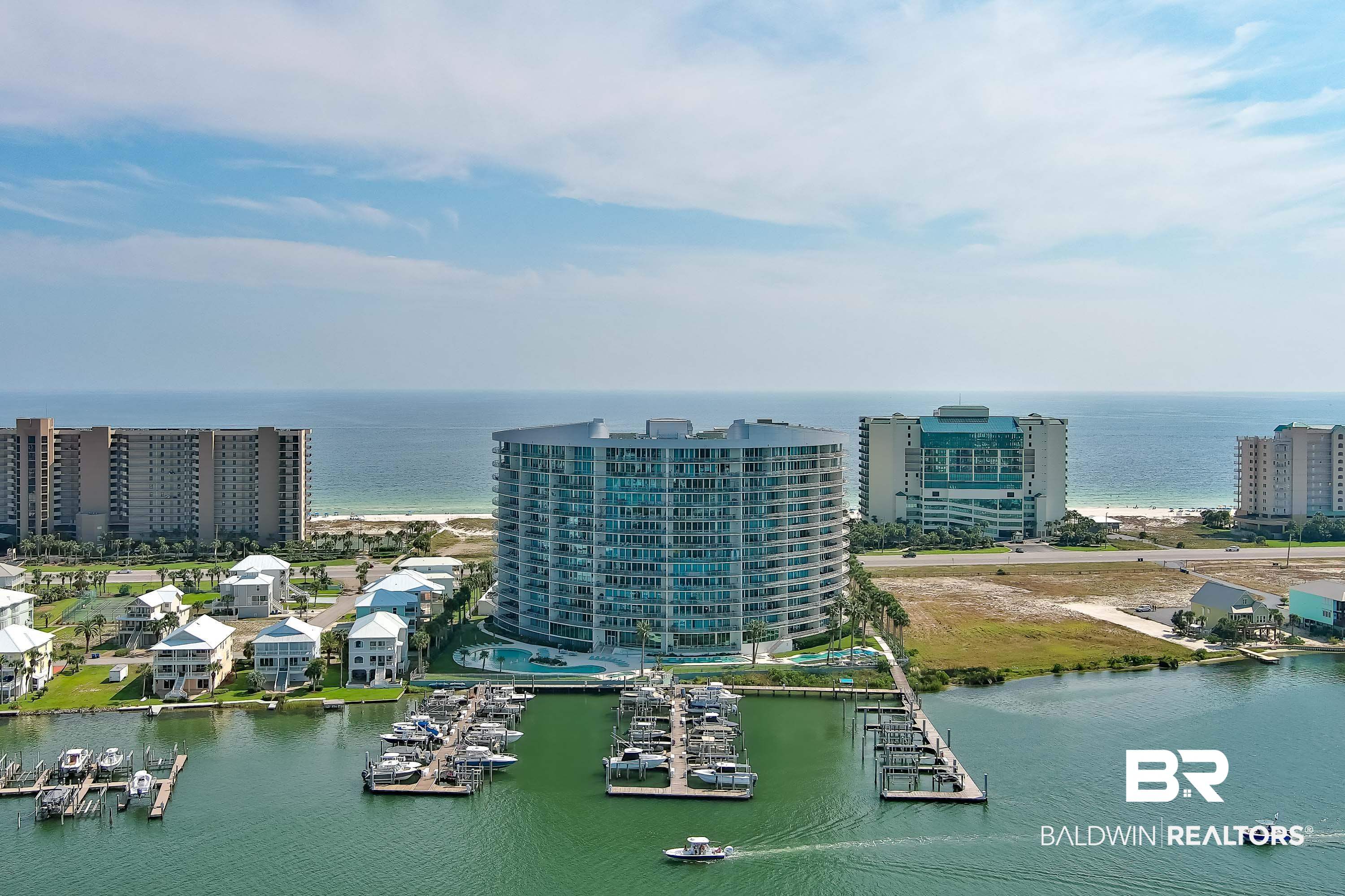 PENTHOUSE 7- BOAT SLIP Included – Slip B17 with New Lift!Don’t miss this rare opportunity to own a Penthouse Suite at the luxurious Bella Luna! This stunning 4-bedroom, 6-bathroom custom condo comes fully furnished and offers over 3,300 square feet of refined coastal living. Enjoy floor-to-ceiling wraparound windows showcasing breathtaking sunset views over both the Gulf and the Bay.  Take in the spectacular sights of Ole River, Cotton Bayou, and Perdido Bay from this west-facing unit—perfect for never missing a sunset. The spacious layout features a gourmet kitchen with stainless steel KitchenAid appliances, a separate wet bar, and beautiful furnishings throughout. Bedroom configuration includes:  King beds the Primary, Secondary and Third Bedroom, the fourth bedroom with two twin beds,  Bella Luna is renowned for its upscale luxury and exceptional amenities, including—but not limited to—three outdoor pools (one featuring a zero-entry design), a heated indoor pool, and hot tubs both indoors and out, Owners Lounge designated for Owners Only with a Theater Room, This PH has two designated parking spots in the covered garage parking below building.  Also enjoy a fully equipped fitness center complete with a sauna and steam room. Bella Luna is truly one-of-a-kind that provides the best of both worlds having beach and bay access. Whether you're looking for a primary residence, second home, or investment property, this luxurious condo delivers on all fronts. Boat slips at Bella Luna are extremely rare and in high demand—this one includes Slip B17 with a brand-new lift.  Schedule your showing today—this one won’t last long! Buyer to verify all information during due diligence.