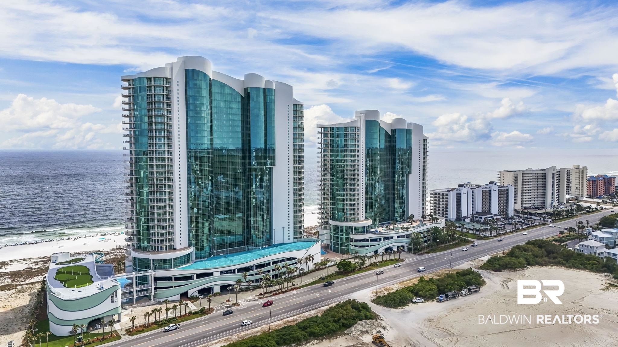 Stunning 26th-floor Gulf-front luxury residence offering 3,504 square feet of beautifully furnished living space and breathtaking panoramic views of the emerald waters and sugar-white sand beaches. This exceptional 4-bedroom, 4.5-bath condo features an expansive private balcony complete with a natural gas grill and private jacuzzi for enjoying unforgettable sunsets and coastal breezes. Inside, elegance and comfort blend seamlessly with 10' ceilings, spacious living areas, tile flooring, and a beautiful living room with gas fireplace and flat-screen TV, all positioned to capture the spectacular Gulf views. The gourmet kitchen is appointed with premium Sub-Zero and Wolf appliances, granite countertops, wine cooler, and ice maker—great for entertaining family and guests. Situated on an impressive 500 feet of pristine Gulf frontage, the resort-style amenities include indoor and outdoor saltwater pools, lazy river, hot tubs, fitness center, sauna and steam rooms, playground, air-conditioned hallways, and four levels of covered parking. A rare opportunity to own a spacious, luxury Gulf-front retreat with world-class amenities and unforgettable views. Buyer to verify all information during due diligence.