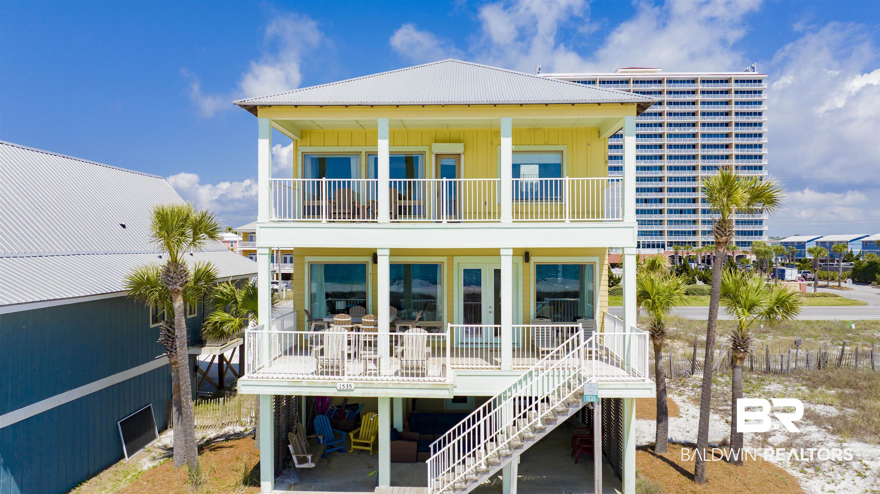 Discover "Easy Day," a spectacular Gulf-front 6 Bedroom | 5 bathroom beachfront home in Gulf Shores that can sleep up to 22 guests. Whether you’re searching for a luxury beachfront getaway or a high-performing vacation rental, Easy Day offers the ultimate Gulf-front lifestyle with space, comfort, and spectacular views.The main living level is designed for gathering and entertaining, featuring a large open-concept living, dining, and kitchen area with expansive views of the Gulf. Beautiful travertine tile flooring, crown molding, and abundant natural light create an inviting gathering space. The kitchen offers quartz countertops, stainless steel appliances, two refrigerators, and a built-in ice maker, providing ample space and convenience for hosting large groups. This level also includes two guest bedrooms, each with ensuite bathrooms.Upstairs, the Gulf-front primary suite provides a private retreat with direct deck access and sweeping beach views. The spacious ensuite bathroom features a soaking tub and separate shower overlooking the Gulf. This level also includes an additional guest bedroom with ensuite bath, a bunk room with twin-over-twin bunks, and an impressive custom bunk retreat with three custom full-over-full bunks, each thoughtfully designed with its own reading light and charging outlets. Outdoor living is where Easy Day truly shines. Multiple Gulf-front decks create incredible spaces for relaxation and entertaining. Enjoy sunrise coffee from the private primary bedroom deck, gather for meals on the main living deck with Polywood dining and lounge seating, or unwind at the beach-level entertaining area.Each living level features it's own laundry room for added functionality, quartz counters and new fixtures in all the guest bathrooms, high end plank flooring in all the bedrooms, gold fortified roof 2024, commercial 85 gallon water heater, professional landscaping w/irrigation.Your beachfront memories start here at Easy Day in Gulf Shores. Buyer to verif