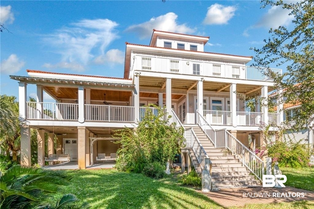 Luxury abounds at this unique one-of-a-kind property. No detail has been forgotten! For starters this expansive home (4 bedroom, 4 full baths & 2 half baths) is situated on a beautiful, tropically Landscaped lot with approximately 90 foot of waterfront on Bayou St. John, complete with a brand new boat dock with boat slip (deep water.) There are too many special details and extras to list but here are a few: Real wood floors, wood columns, wood custom molding. Third floor widows walk that has 360° views, including views of Bayou St. John, Terry Cove, Johnson Cove, and the Gulf of Mexico. Custom windows including custom made stained glass above the windows on the main floor. Impact windows and doors. 4 large bedrooms, each with its own private en suite bathrooms complete with televisions. Three of the bedrooms have beautiful water views and open to a porch/deck. Elegant hotel style elevator that fits 4-5 adults. Functioning Central Vacuum system. Bonus room with breathtaking vaulted wood ceiling and custom arched window. 4 car garage with expansive storage area and half bath. Large laundry room. Custom made wrought iron staircase railing molded from “Birds of Paradise” design from the famous Pontalba building in Jackson Square (New Orleans). Outdoor shower. Granite countertop in kitchen. First floor master bath has a Swedish spa tub. Four air conditioning units, three of which are recently new. Reinforced bulkhead. Separate storage shed. All appliances to remain. Attached TVs will remain. Hanging porch swing will remain. The following items will remain with the seller and NOT TRANSFER:  Drapes in 1st and 2nd floor master bdrm  Chandelier in the kitchen dining area  Sconces in the foyer (bronze)  Ceiling Fan in 1st floor master bdrm  No concrete statues to remain  Two-seater free standing porch swing  Red Curtains and curtain rod in 1st floor bonus rm (chapel rm)  All updates per seller. Listing Co makes no representation as to accuracy of sq. footage; buyer to verify.