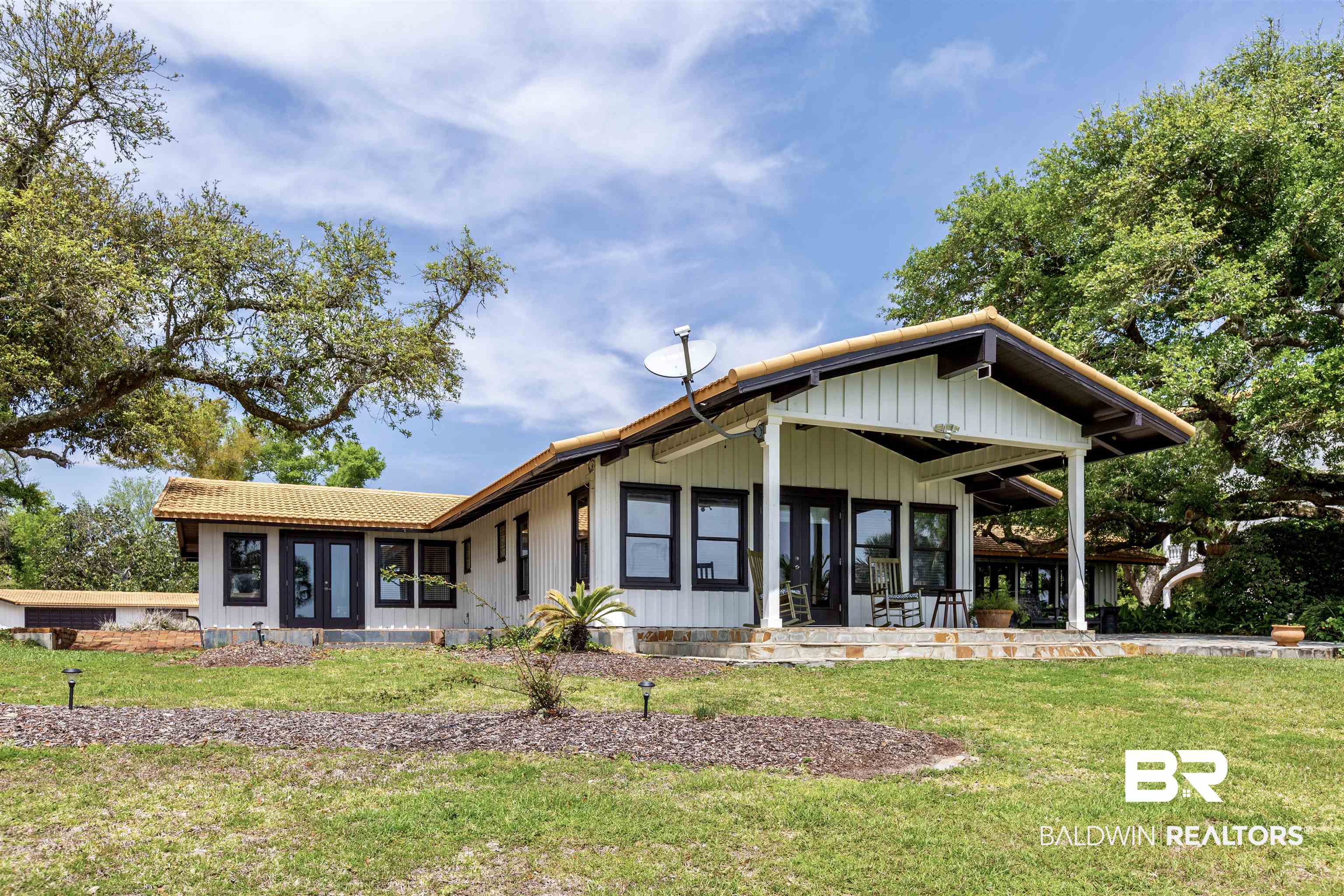 Here is your opportunity to own the coveted waterfront property on Bayou Saint John which rarely comes on the market. This 3090 sqft home sits on over 2.87 acres of pristine property surrounded by live oak trees and 136 ft of your own private beach. The hand laid brick drive lined with 30 wrought iron lamp post and gas lanterns is as equally impressive as the breathtaking waterfront views. This contemporary cottage has a low maintenance open floor plan making it perfect for a primary or secondary residence. Each room is exceptionally large giving plenty of room for beds and sofas for lounging. The vaulted wood ceilings are a lovely complement to the white washed walls and tile floors. The updated kitchen offers space for cooking and entertaining around the bar and kitchen island. The large patio is perfect for hosting parties or relaxing as you watch the boats pass from sunrise to sunset. This gorgeous landscaped property includes beautiful gardens, elaborate water features and a detached two car garage with full bath and flex space (perfect for a guest or workout  area). THE OWNER RESERVES THE RIGHT TO MAKE THE SALE OF THE SUBJECT PROPERTY CONTINGENT UPON THE SALE AND SIMULTANEOUS CLOSING OF THE ADJOINING HOME OWNED BY THE SELLER. the Description of 2nd property is attached as a document or visit MLS#345747