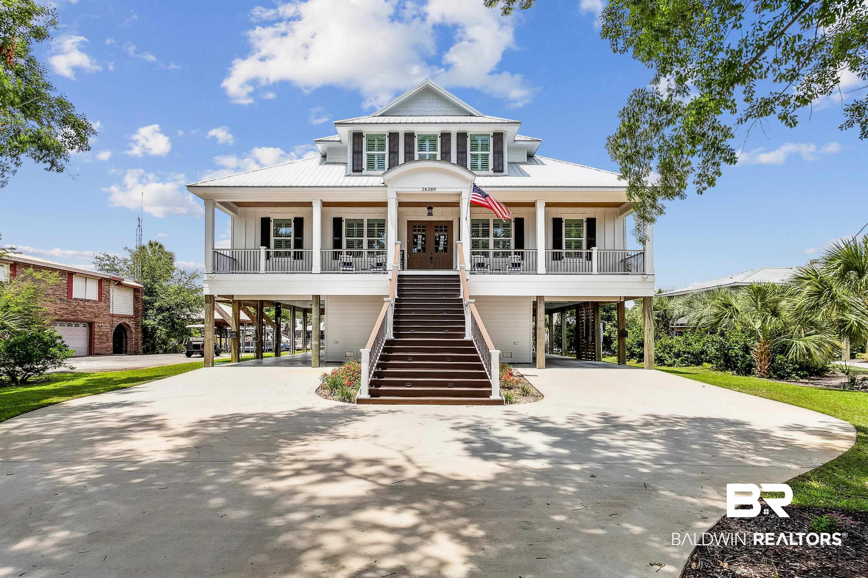 Marina Road Manor! Shaded entry to this fabulous GOLD-FORTIFIED coastal home. Incredibly detailed large canal-front home in Central Orange Beach. Golf cart or bike to popular restaurants, bars, OB Marina, and grocery as well as the beautiful State Park. Located on wide canal that leads to Terry Cove and puts you into the ICW and the Gulf in minutes. Expansive great room with custom cabinetry, surround sound, large chef’s kitchen offering commercial size refrigerator and freezer, gas cooktop, wet bar, walk-in pantry, etc. Main home sleeps 10+ and offers three bedrooms/two full baths/one half bath.  Large primary suite has spa shower, walk-in custom closet, double vanity, extra closet and lots of storage. Guest apartment offers covered access to main home plus living room, kitchen, bedroom and full bath. The must-see waterfront veranda is 53 ft x 12 ft with space for multiple seating areas and it is pre-plumbed for an outdoor kitchen. Swimming pool, two boat slips (one covered), elevator with access to all floors, WHOLE HOME GENERATOR, in-home office, walk-in attic, multiple storage rooms, extensive parking, alarm system, no HOA. TOO MUCH TO LIST HERE ---- THIS IS A MUST-SEE PIECE OF PARADISE!