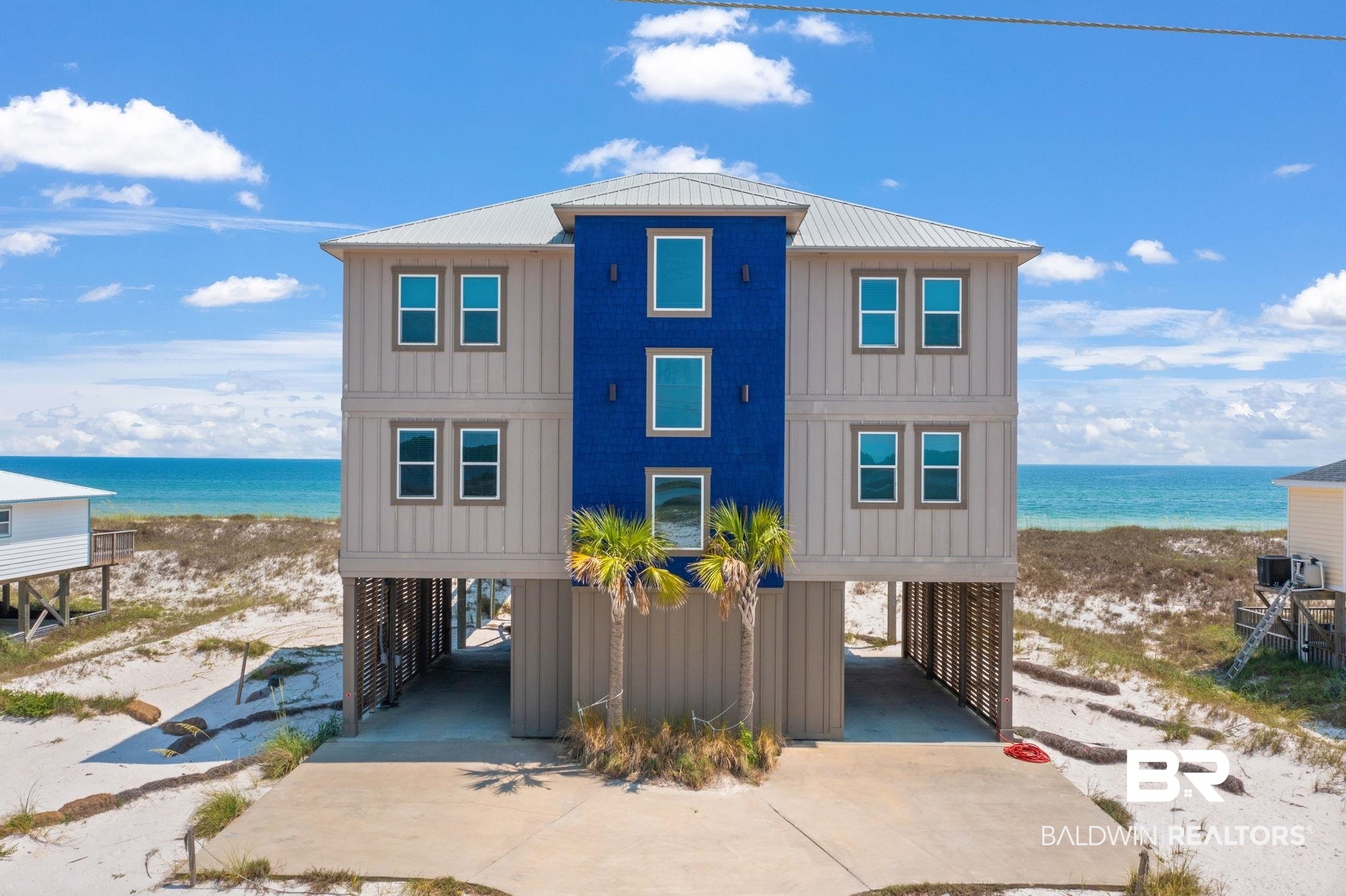 Sunswept... Get swept away with the beauty and quality of this Beach Front Home right on the Gulf of Mexico.  Built in 2018, Gold fortified and all high end features. Tall ceiling heights, 6 bedrooms and 6.5 bathrooms. An Elevator that services all three levels, impact windows and doors, granite countertops and ceramic tile throughout. Walk right out of the main level to enjoy the heated pool while sipping a drink and watching the sunset, all decks and porches are composite decking and aluminum railing.  Your own private boardwalk takes you from the main level of the home across the dune right to the beach. Primary Bedroom leaves nothing to be desired with it's huge glass sliding door leading out to the stunning views of the sand and water. The primary bathroom features beautiful stone and tiled walk in shower with dual shower heads and rain heads, soaking tub, double vanities, private toilet room, featuring Toto toilet seats and the walk-in closet with its own laundry appliances. Dramatic full height kitchen cabinetry with built in lighting. The Appliances WOW, with a dual fuel commercial style range, 2 fridges, 2 dishwashers and ice maker.  The high end features continue upstairs where you'll find Two, Gulf Front Master Suites with sliding doors and their own balcony, 2 Lagoon Front Master Suites and the 6th bedroom, also Gulf Front, and hall bathroom. Sitting area, 2nd Laundry Station, and the wet bar with 2nd ice maker, coffee service and wine fridge.  Make this your second home or keep it as an income producing rental.