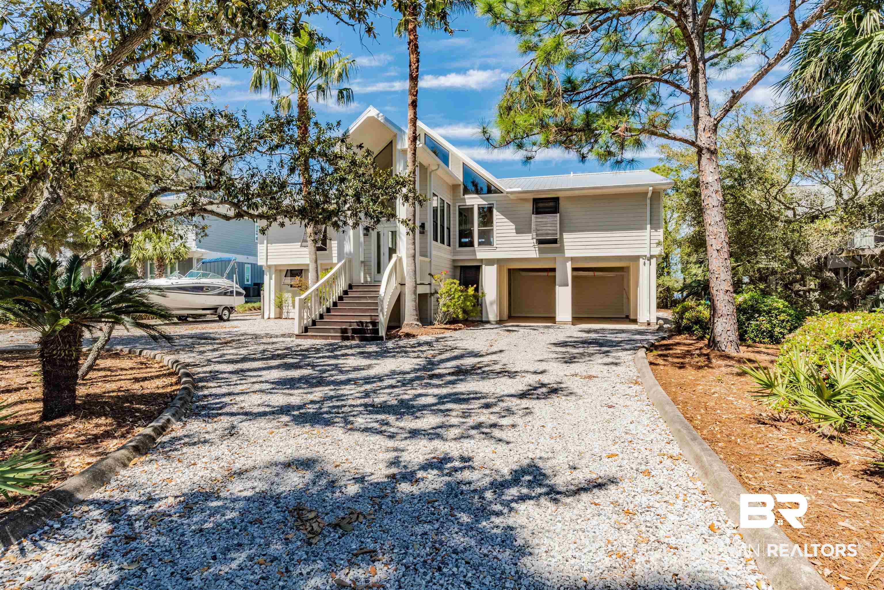 Discover this boater's paradise located on exclusive Ono Island. Relax on the expansive boat house and catch an amazing sunset after a day on the water. The boat house has been newly constructed with thru flow decking, new pilings and entertainment area featuring a sound system with wifi/cable, bar area while housing two boat lifts. Entertain at your private pool while grilling the day's catch on the open balcony. Enter inside to be captivated by bay views from the kitchen, living area and primary bedroom. House guests downstairs with their private quarters featuring a large bedroom, full bath and bunk room. If a luxury island retreat is what you've been looking for, we found it!