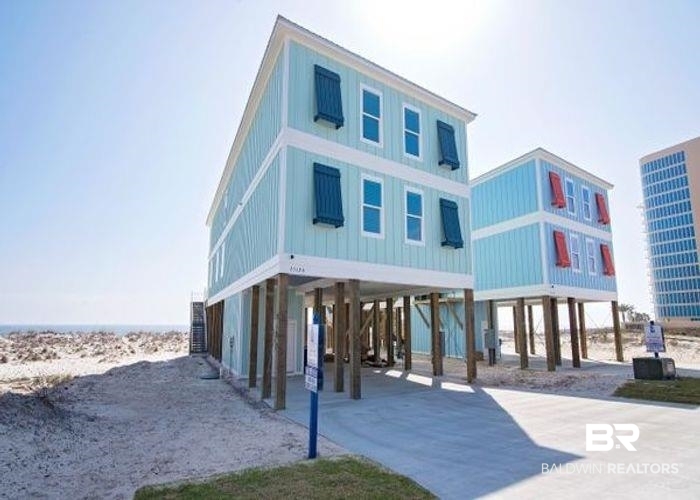 Welcome to "Orange Beach East" raised beach cottage! This 8bdrm/7.5bth home is a rare find in Orange Beach and offers a tremendous rental history, sleeping up to 32 guests! Built in 2017, this home is "Gold Fortified" offering all the latest amenities for its clients.... shiplap accent walls, SS appliances, 2 frigs, 2 dishwashers, 2 ranges, large dining table with seating to accommodate guests, LVP flooring, beautiful tiled bathrooms, bunk rooms for the kids, flat screen TVs, several guest suites offer private gulf front balconies, main living room is large, newly decorated and spacious for guests to spread out, 2nd level Living Area is perfect for the entertaining on movie nights, elevator, outdoor pool w/ heater, grilling area downstairs and so much more! This homes rental history was incredible 2022 and looking even better for 2023! Rental history is available upon request.