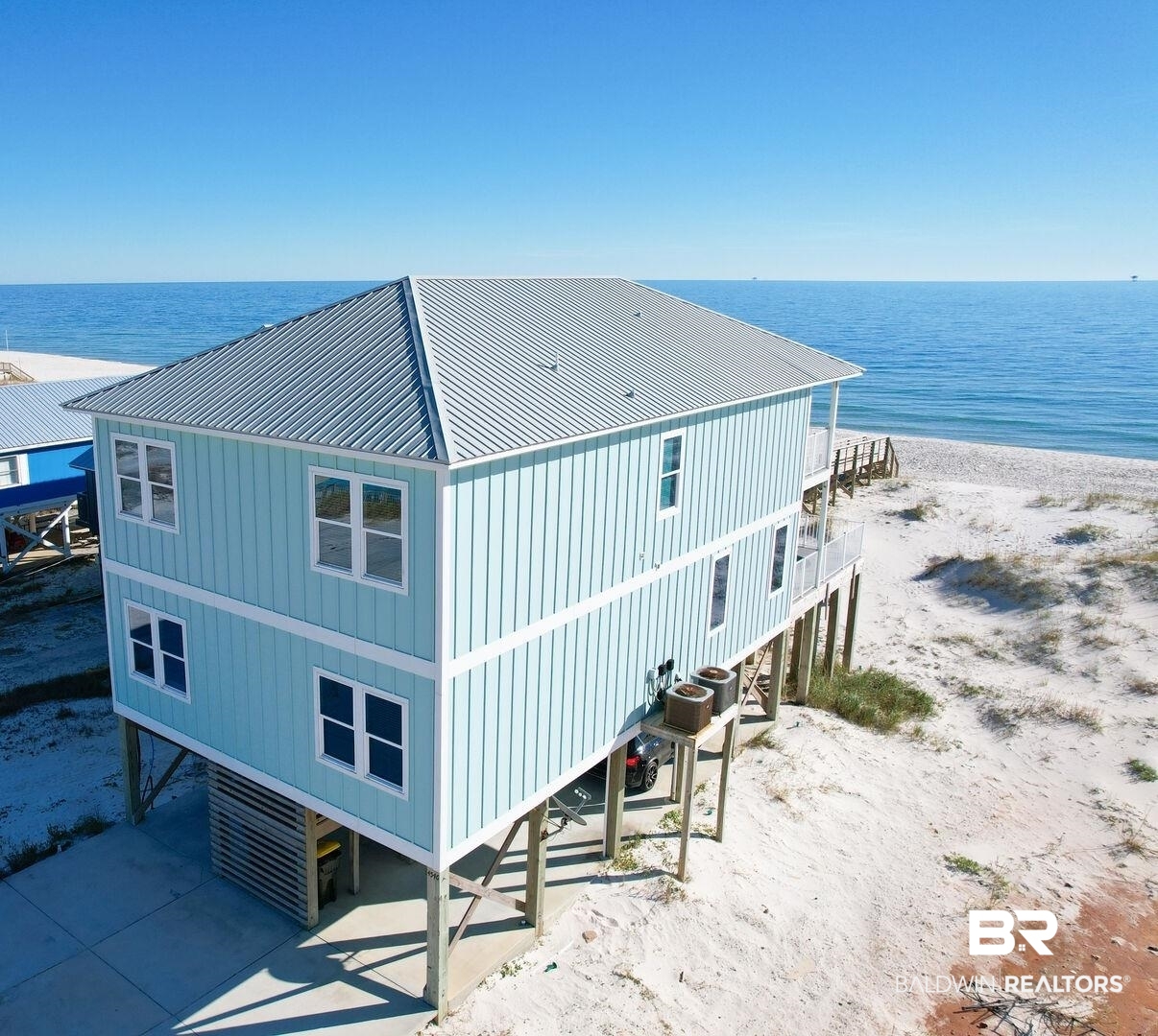 Attention investors! Come see this well designed beachfront beauty. 7 bedrooms, 7.5 baths and two dens provide plenty of space for everyone! All bedrooms have en-suites providing an extra measure of privacy. Relax in the private heated pool and deck directly looking over the white sandy beaches and Gulf of Mexico. Gold Fortified construction helps keep insurance lower to maximize your return. Sold fully furnished, this home is completely turn-key.