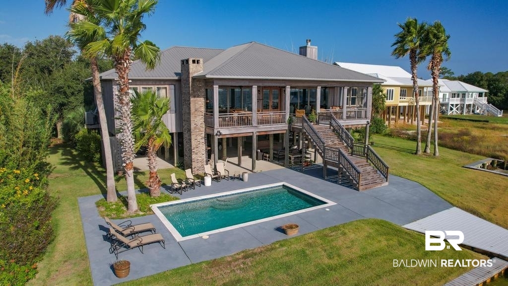 This 5-bed, 4.5-bath home spans 3,840 square feet of character and charm, all thoughtfully designed on a single level. As you step inside, the great room features two huge sliding glass doors, a rustic brick fireplace, and a convenient wet bar for all your entertainment needs. Top-notch stainless steel appliances and a spacious island throughout the kitchen. Two exterior fireplaces, located on back porch and lower level. This is a boater's paradise, brand new boat house with three lifts, and deep water for large boat. Situated on an expansive 110X181 waterfront lot, this property offers an in ground pool and breathtaking views of Bayou Saint John. Buyer to verify all information during due diligence.