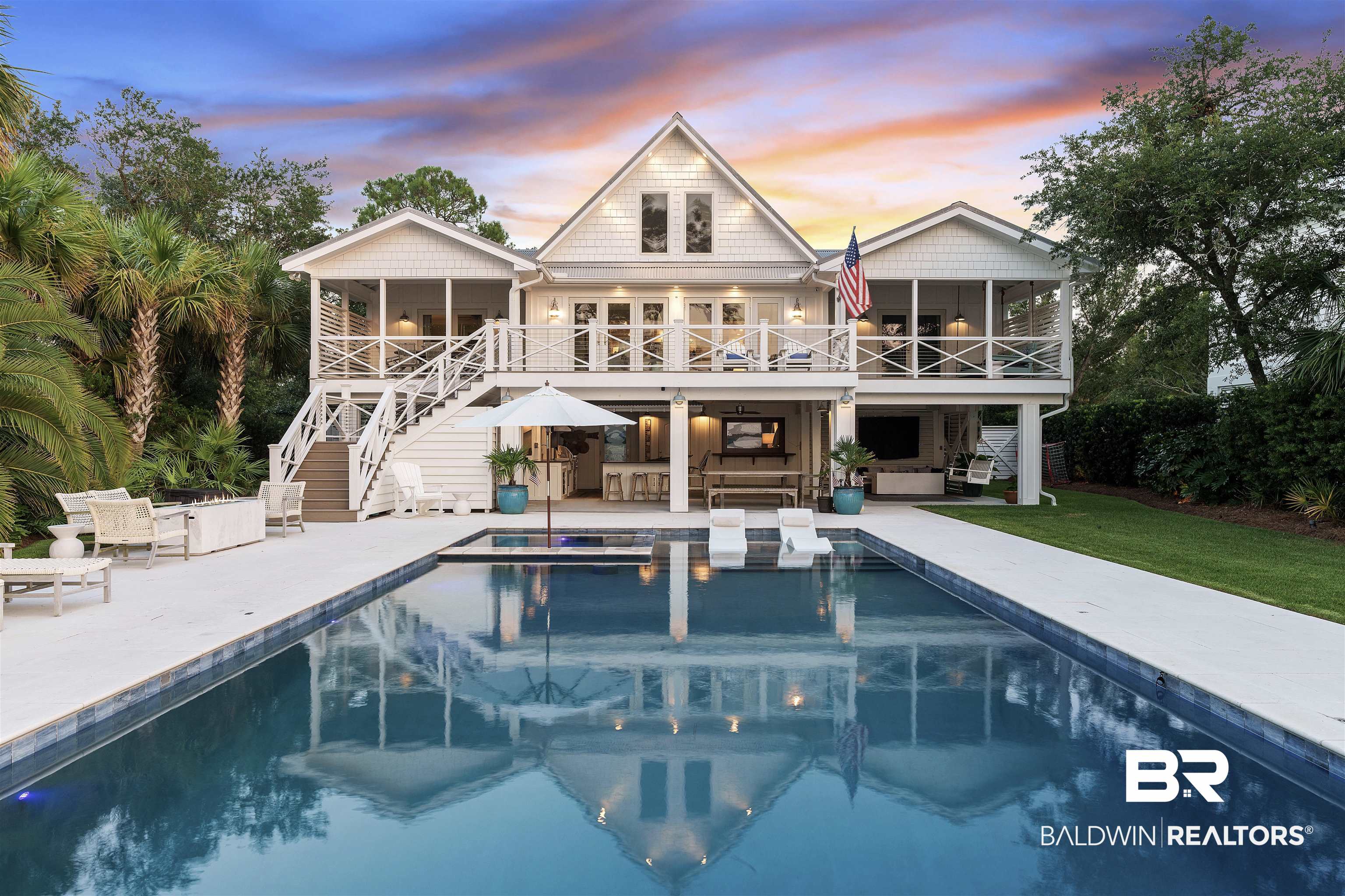 Located on the northern side of Ono Island, this custom remodeled home offers breathtaking panoramic bay views. Inside, you'll find heart pine floors, shiplap accents, exposed beams, Calcutta Manhattan Belle marble countertops, and top-of-the-line appliances. The kitchen is equipped with a Wolf 48” duel fuel range, Wolf 48” Pro wall hood, Subzero refrigerator, Subzero beverage cooler, and a Miele coffee system. Step outside onto the spacious porch, which overlooks the meticulously landscaped yard and pool area. The seawall includes a custom inlet, ensuring effortless access to the bay, while offering breathtaking scenery. The pier carries you to a covered dock, complete with 2 boat lifts, a piling mounted with a jet ski lift and a covered bar. Both lifts have a capacity of 10,000 pounds, with one being covered and the other uncovered. Relax after a day on the water in your outdoor oasis, which includes a pool with a hot tub, an outdoor kitchen and poolside shower. The outdoor kitchen features granite countertops, built in Lynx grill, Lynx burner and a commercial grade 48” griddle. Other features of this home include; Anderson impact windows and doors, updated wiring, tankless water heater, updated plumbing, underground Blossman propane tank, and a cozy gas fireplace. This home is conveniently situated just a short stroll away from the Ono Island community center and private boat launch. Experience the epitome of coastal living at its finest!