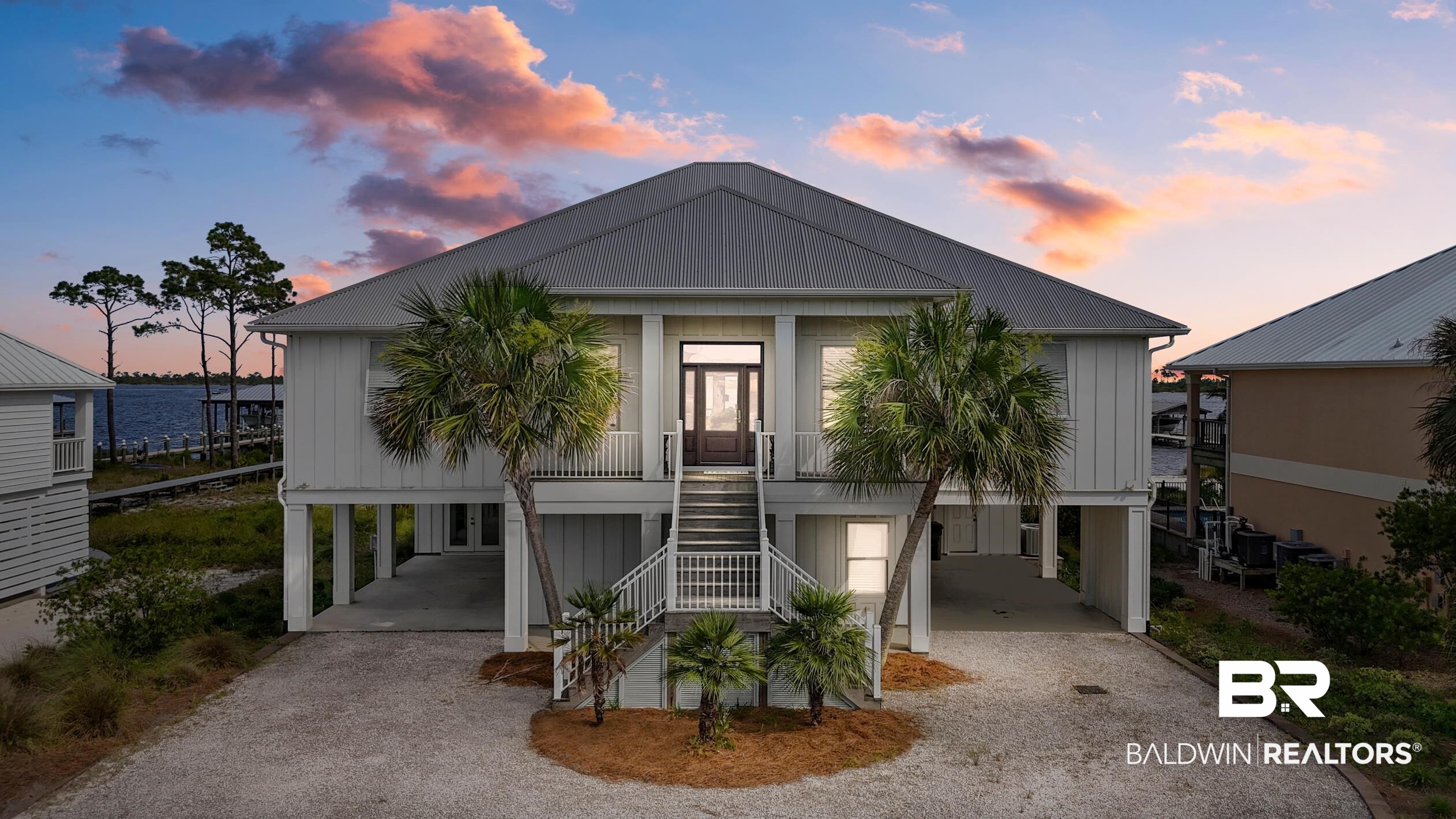 Experience the unbelievable view from this 2014 built  J.L. Loper home on Ono Island overlooking Ole River. The home has been exquisitely decorated by Brandice Griffin of Interiors by Brandice and will be sold partially furnished! Enjoy your huge screened in porch overlooking your  boat dock with 2 boat lifts and unobstructed views of Ole River. This 5 bedroom 3.5 bath home  offers a spacious kitchen with gas stove and  bakers pantry with plenty of cabinet space.  Schedule your showing today to see this River Road home on the private gated community of Ono Island. A perfect waterfront refuge with 3478 square feet of living space equipped with an elevator and plenty of room for your family and friends.  Highly sought after LOCATION!  Live in Paradise. This home is a musts see. Buyer to verify all information during due diligence.