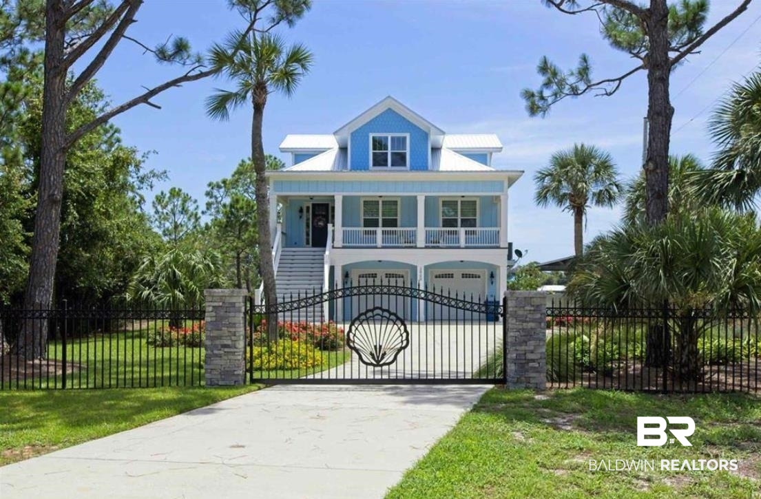 Welcome to this stunning custom-built home on protected deep water, just minutes from the Pass and the Gulf of Mexico. Built in 2018, this Gold-Fortified residence features a concrete board exterior, a privacy stone stacked and wrought iron entry fence and a custom gate with security system. Inside, you'll find 8' doors, custom lighting, elegant drapes, and transitional shades throughout. An elevator provides easy access to all levels. The main area boasts a stylish entryway with a staircase, leading to the Great Room with a stone-stacked fireplace, built-in shelves, and a bay window in the dining area. The gourmet kitchen includes quartz countertops, a custom-tiled backsplash, stainless steel appliances, a 5-burner gas stove, a farmhouse sink, and a glass pantry door. The main level also has two guest bedrooms, 1.5 baths, and a laundry room with a barn door and ample storage. Large windows and French doors offer stunning water views and lead to a spacious balcony. Upstairs, a small office or dressing room is off the foyer. The primary bedroom features magnificent furnishings, water views, a large walk-in closet and balcony access. Outside, enjoy a brand new heated saltwater pool and hot tub with a waterfall, a boathouse with an extended bulkhead for multiple boats, and a new cabana with an new outdoor kitchen. The gated property includes a security system, and a recent $126,000 investment in new concrete driveway and landscaping enhancing the vibrant surroundings. With 272' of waterfront footage & new seawall, this home offers breathtaking sunset views. All furnishings convey with the property, and a 27' boat, trailer, and golf cart are available for purchase, allowing easy access to the nearby beach. Experience luxurious coastal living at its finest in this exceptional home. Buyer to verify all information during due diligence.