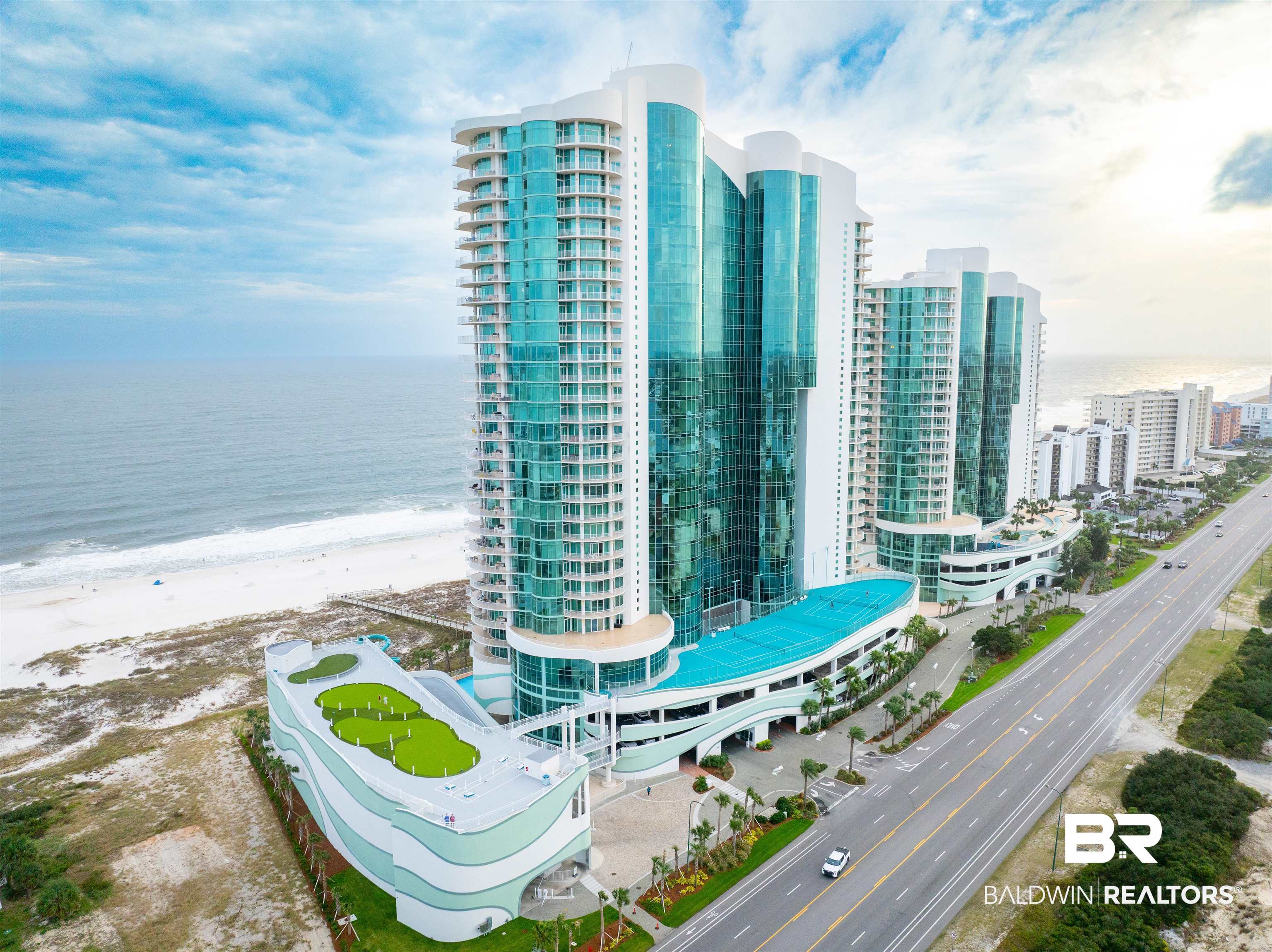 Perched on the 23rd floor on a stunning 500-ft stretch of pristine Gulf frontage at the renowned and luxurious Turquoise Place in Orange Beach, Alabama, this exquisite Gulf-front condo offers unparalleled elegance and world-class amenities. The sophisticated interior features premium WOLF & Subzero appliances, sleek granite countertops, a cozy gas fireplace, a wine chiller, and an ice maker, complemented by fresh paint and beautifully updated carpet and flooring as of November 2022. The expansive wraparound balcony boasts breathtaking and uninterrupted views of both the sparkling gulf waters and the picturesque Intracoastal Waterway. Complete with your very own grill and an indulgent hot tub, it’s the perfect setting for relaxing in style. Enjoy access to state-of-the-art workout rooms, meticulously maintained tennis and pickleball courts, two resort-style outdoor pools with a lively kids' splash pad, and heated indoor pools with a rejuvenating sauna, steam room, and a serene heated lazy river. The brand-new amenities deck includes a professionally designed putting green, an enchanting movie amphitheater, and a thrilling 300-ft slide. To top it all off, the conveniently located onsite Change of Pace restaurant makes dining effortless. Experience the epitome of coastal living with mesmerizing sunrises, golden sunsets, and unforgettable family memories waiting to be cherished! Buyer to verify all information during due diligence.