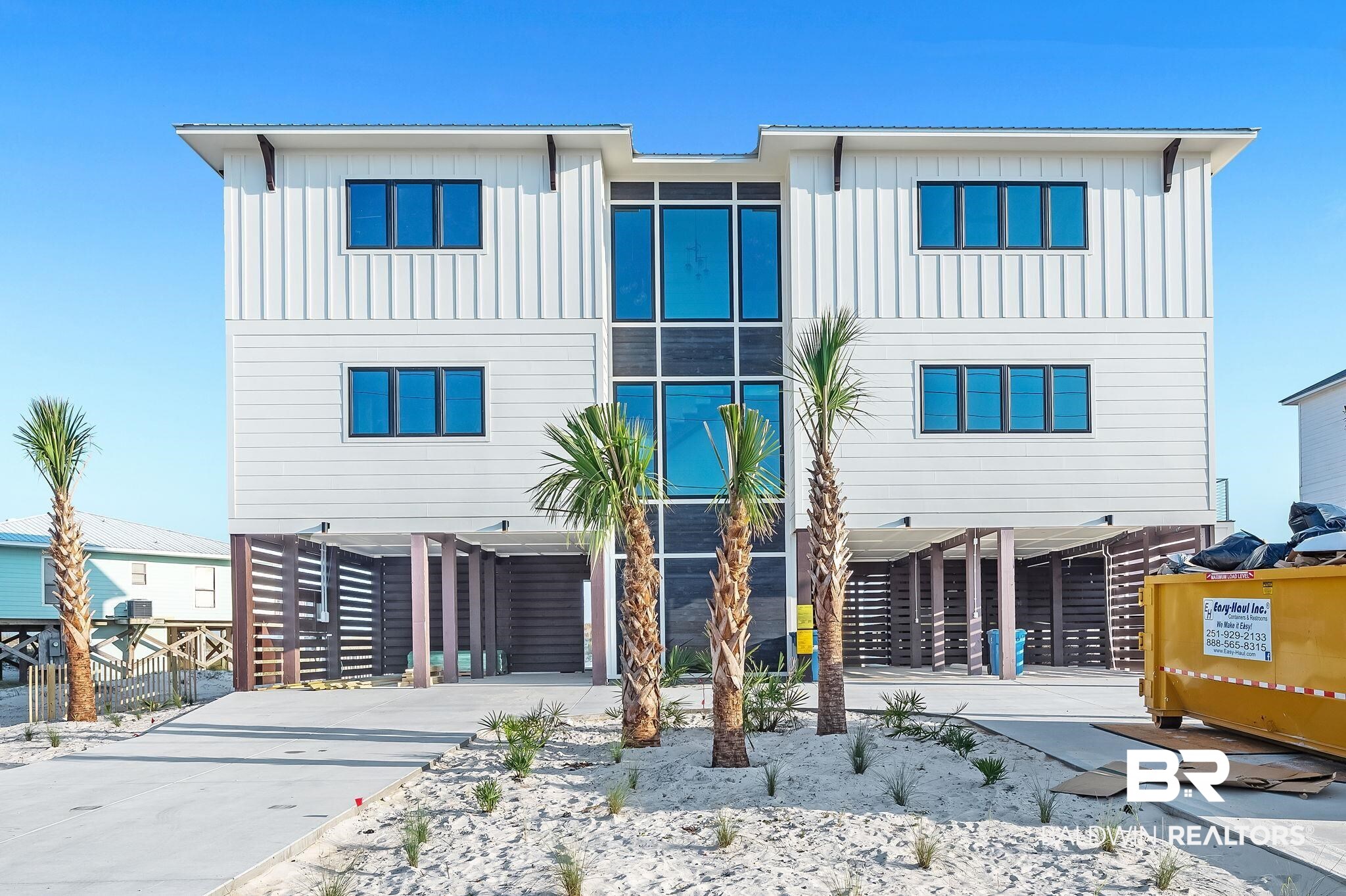 One-of-a-Kind Gold Fortified Gulf Front Beach Home – 7 Beds 7 Full + 2 Half Baths. 5,300 SF, Sleeps 26. Discover a rare opportunity to own a breathtaking new construction Gulf-front estate on an oversized lot, offering 5,300 SF of luxury living. Designed to be a private oasis, an extraordinary second home, or a high-performing investment property, this stunning residence combines cutting-edge modern design with top-tier amenities and panoramic water views from every room. Sleeps 26 comfortably with spacious, well-appointed suites, including a large master with Gulf-facing deck, a luxurious en-suite bath with dual stone vanities, soaking tub, and glass shower. Family bedroom with king bed + 2 sets of bunk beds separated by barn doors perfect for guests of all ages. Direct private boardwalk to the beach with a unique split-stair design access from the pool or lower level. 12x22 propane-heated pool with a 20' bench for relaxing soaks. Over 1,200 SF of decks with stainless steel railings and CoolTeck decking for heat control. Lower-level lounge retreat with 65” drop-down TV, outdoor shower, and a convenient half bath. Custom kitchen with wet bar, full-size refrigerator and freezer, dual dishwashers, 48” gas range, ice maker and walk-in pantry. Stunning 10’ waterfall island with under-lighting and coffered ceiling with accent lighting.  Wide plank white oak engineered hardwood floors, Floating staircase and glass-walled circular elevator, a showpiece of architectural design. 10’ ceilings on main and second floors, 12’ ceilings on lower level. Sound system in all common areas and decks. A beautiful modern three-sided electric mist flame fireplace in the great room.  Every detail of this one-of-a-kind coastal retreat has been meticulously crafted for the ultimate beach lifestyle. Buyer to verify all information during due diligence period.  Buyer to verify all information during due diligence.