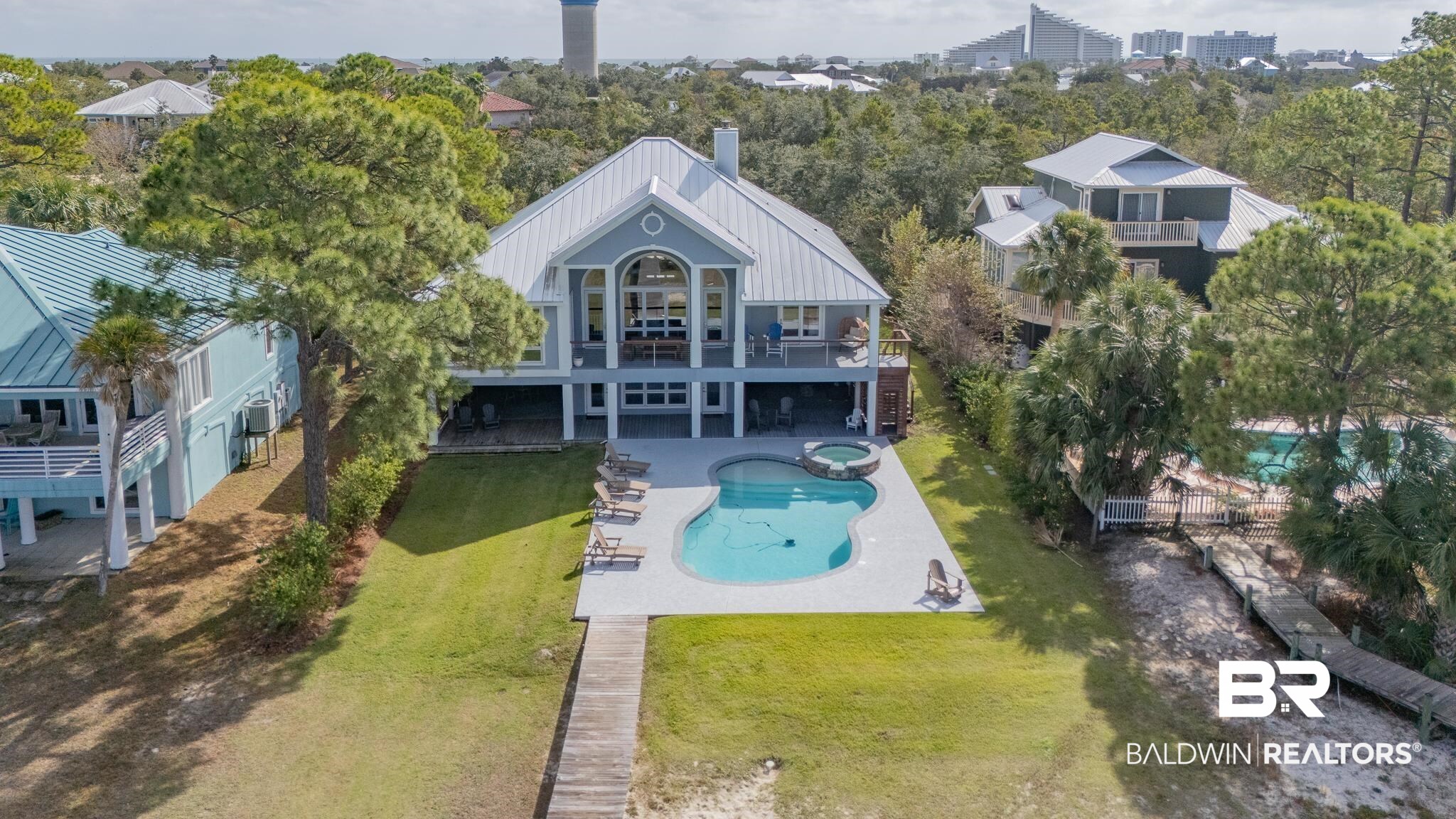 Experience waterfront living at its finest in this exceptional bayfront residence on Orange Beach's coveted Ono Island. This spacious 3,654-square-foot home features six bedrooms and six bathrooms, perfectly designed for both family living and entertaining. Step inside to discover soaring ceilings and walls of windows that flood the home with natural light while showcasing stunning bay views. The open-concept layout creates an effortless flow between the living spaces, making it ideal for gatherings large and small. The well-appointed kitchen stands ready to inspire your inner chef with its gleaming granite countertops, stainless steel appliances, and a generously sized island perfect for casual dining or prep work. The primary bedroom suite offers a peaceful retreat with breathtaking water views, while the remaining bedrooms provide comfortable accommodations for family and guests. Living areas are anchored by a cozy fireplace, adding warmth and ambiance to cool coastal evenings. Outdoor living is equally impressive with a new saltwater, Gunite, pool and hot tub, perfect for year-round enjoyment thanks to the heating system. The expansive terrace provides an ideal setting for outdoor dining and entertaining while taking in the magnificent bay views. For boating enthusiasts, a new private dock with boat lift awaits your watercraft. Located just minutes from Perdido Key State Park, this home offers easy access to pristine beaches, dining, and shopping. Whether you're watching dolphins play in the bay or enjoying sunset views from your terrace, this waterfront haven delivers the perfect blend of luxury and coastal charm. Buyer to verify all information during due diligence.