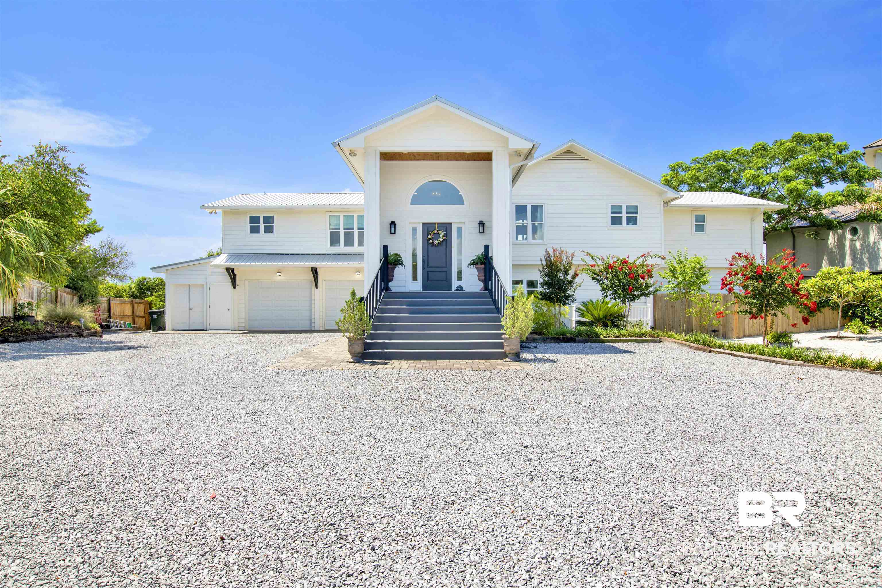 Boaters Paradise....Deep water.....Amazing views.....Embrace the essence of island living with this stunning 4-bedroom, 3-bathroom retreat on one of the most beautiful lots on Ono Island. Renovated in 2019–2020, this coastal gem features a new roof, sleek energy-efficient windows, and beautifully refreshed bathrooms. Rich with character, the home is adorned with solid cypress doors reclaimed from The Bank in New Orleans, adding a touch of Southern charm and history. The breezy, open-concept layout seamlessly connects the living, dining, and kitchen areas—perfect for laid-back entertaining. Step outside to soak in the salt air on the expansive screened porch, two upper-level patios, or lounge by the heated saltwater pool in the shaded outdoor living space. For boaters, a private pier leads to a well-appointed boathouse with a covered 12,000 lb lift and an uncovered 27,000 lb lift—ready for all your coastal adventures. Move-in ready and thoughtfully upgraded, this waterfront haven offers the ultimate island life escape with every luxury at your fingertips. Home is being sold partially furnished. Buyer to verify all information during due diligence.