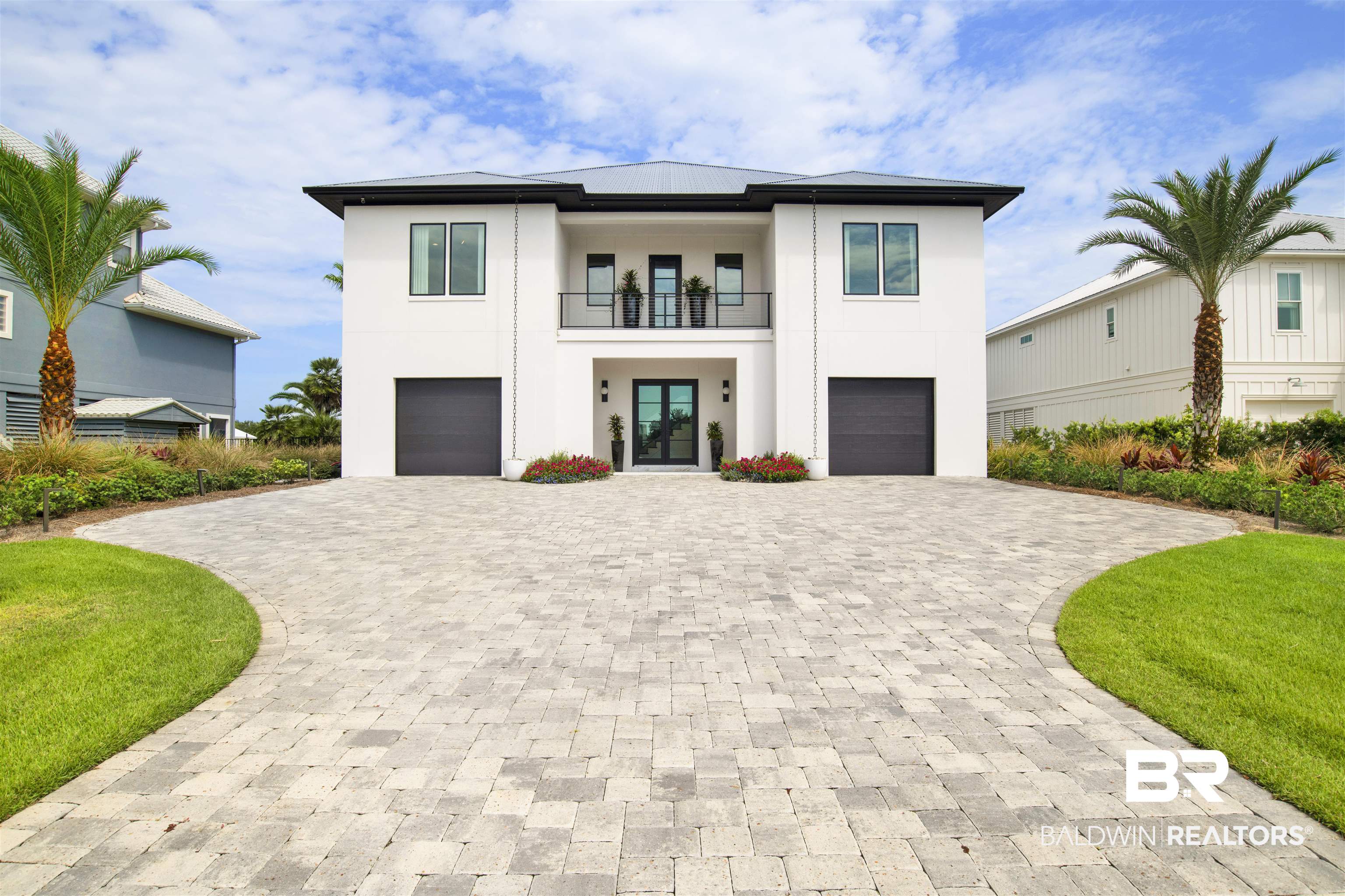 Step inside to discover a rare chance to own a turnkey home where coastal elegance meets contemporary chic. This striking Ono Island home, designed by Bob Chatham and built by Phillip Vlahos Homes/Vlahos DeBogory & Tuck Construction, with interior design by Cindy Meador of Cindy Meador Interiors is truly a creation of a talented team. This home has been featured in multiple magazines & dubbed "art in itself". The beautiful paver driveway leads you to a striking double-door entry, a fitting introduction to the luxury that awaits inside. Whether you arrive by elevator or ascend the beautiful staircase adorned with a custom wall mural, the sense of awe upon entering the living room is the same. At the heart of the home lies a designer kitchen, defined by sleek lines and premium finishes, high-end Z Line appliances, complete with a well-equipped pantry for the discerning chef. Outside you will find that the combination of a spacious patio and sleek infinity pool provides an ideal backdrop for entertaining. An exceptional bonus on the first level is the 2,081-square-foot climate controlled garage, completed with a bar and entertainment space—all while still accommodating up to six cars and a golf cart. The 4th bedroom/in-law suite is also located on the 1st level creating the perfect retreat for guests or extended family. Thoughtful design and custom luxury touches throughout make this home truly one-of-a-kind. This home will convey completely furnished along with a whole house generator. Buyer to verify all information during due diligence.