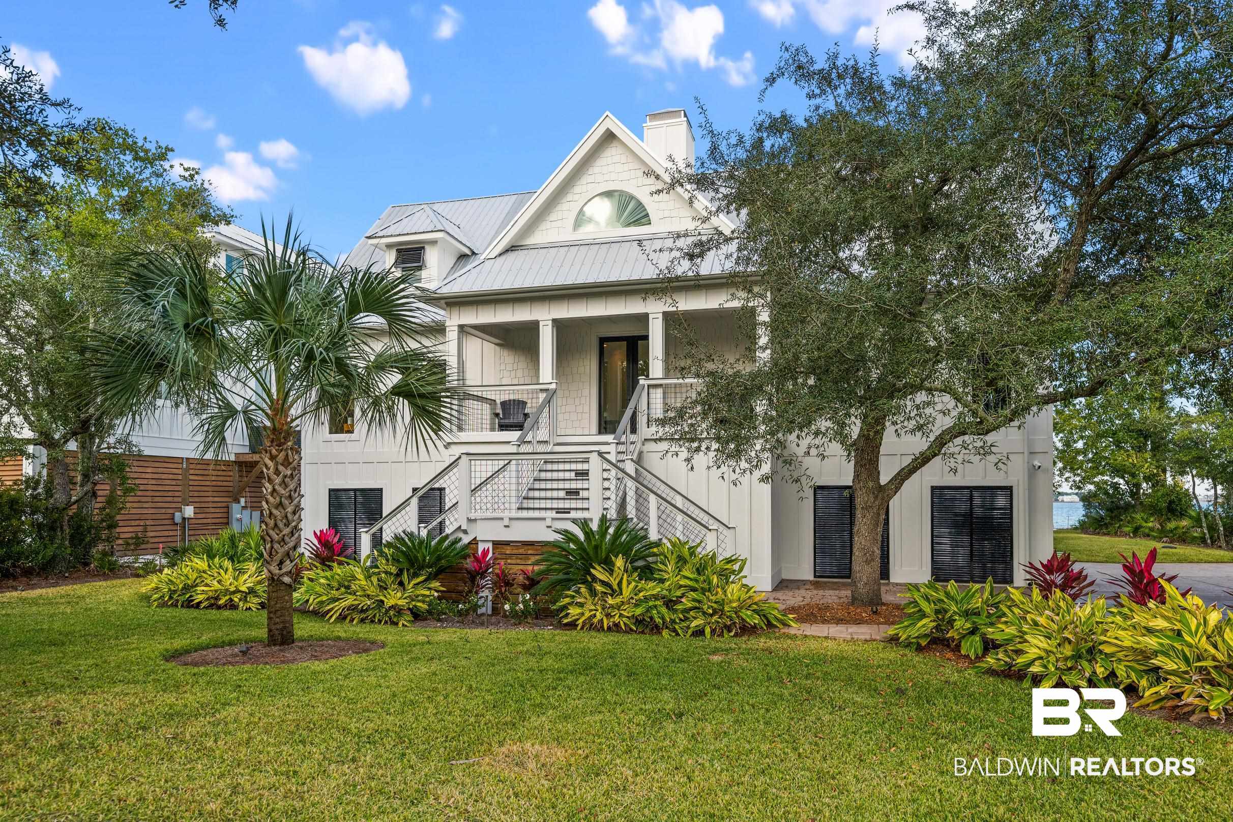 Welcome to this extraordinary waterfront sanctuary on Ono Island, beautifully positioned along Bayou St. John with serene views and effortless access to the Gulf Coast’s most coveted waters. Thoughtfully reimagined inside and out, this 3,016 sq ft, 3-bedroom, 3.5-bath masterpiece blends modern luxury with relaxed coastal living. The property features a deeded boat slip with a 16,000 lb lift in Ono Island Harbour, plus a brand-new entertainment dock, creating the ultimate setup for boating, fishing, and sunset gatherings. Indoors, every surface has been elevated—new tile flooring, a custom chef’s kitchen with premium appliances and quartz counters, a sophisticated wet bar, and completely renovated bathrooms.Outdoors, enjoy resort-quality living with a heated saltwater pool, new composite decking, lush landscaping, and full irrigation. Enhanced with hurricane-impact windows, a new fortified roof, Generac generator, whole-home WiFi automation, and a state-of-the-art entertainment system, this home delivers unmatched comfort, durability, and style. A rare turnkey offering on one of the Gulf Coast's most private islands. Buyer to verify all information during due diligence.