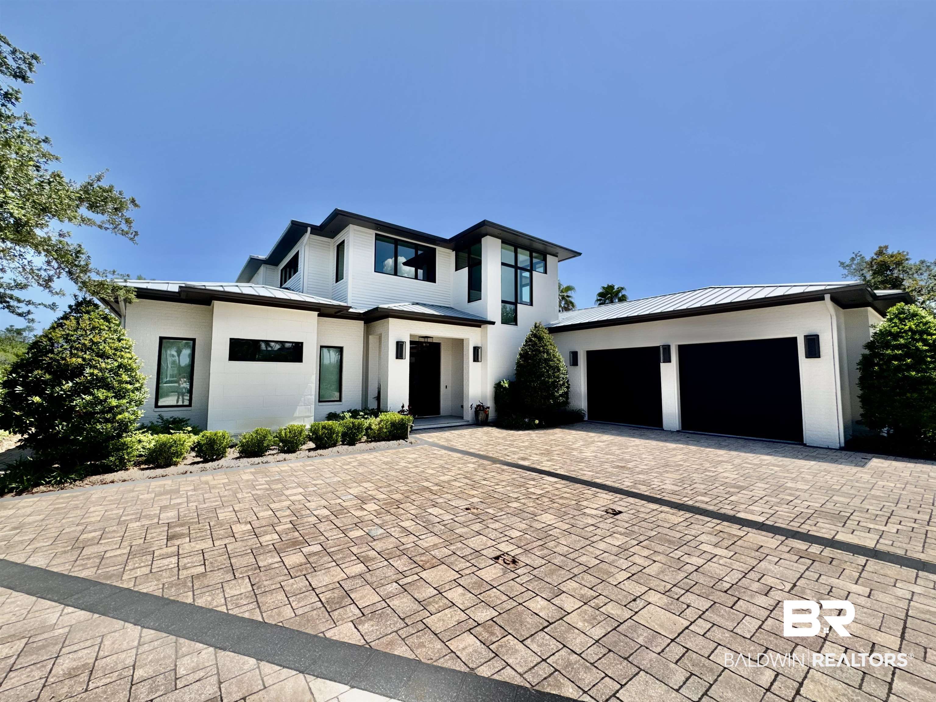 This fabulous GOLD FORTIFIED home is located on Old River with 90 feet of deep-water frontage. The property offers convenient access to the Gulf and features a covered private boat dock with dual boat lifts and jet ski lifts. The dock has both power and water. The outdoor living area is incredible and includes a covered entertaining space, outdoor kitchen, ventless gas fireplace, beautiful swimming pool, an outdoor shower and a half bath. Interior features include wood and tile flooring, custom cabinetry, stone accents, designer lighting, and stone countertops throughout. The home offers 5 bedrooms and 4.5 baths, currently set up as 4 bedrooms and an office. The gourmet kitchen is equipped with Wolf and Sub-Zero appliances including a gas range, dual ovens, and two dishwashers. The dining area includes an entertainment bar with an ice maker.The primary bedroom suite includes a dual-entry stone shower, dual water closets with bidets, two walk-in closets and abundant natural light. Additional property features include expansive covered porches, a two+ car garage, whole home generator, security system, and indoor elevator. The home is being sold furnished as shown, with the exception of the heron painting, the sailboat painting, and the metal herons by the outdoor fireplace. This home is incredible, a modern masterpiece that must be seen to be appreciated. Schedule your showing today! Buyer to verify all information during due diligence.