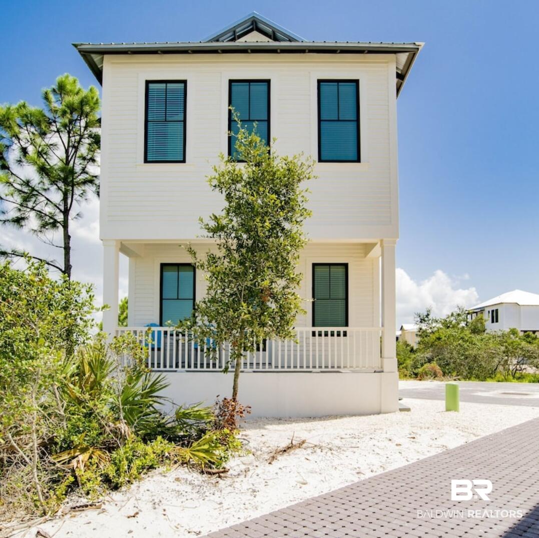 Coastal living at its finest! This stunning 2-bed, 2.5-bath beach cottage has the perfect blend of seaside relaxation and nature. Nestled in a premier community, it is an ideal getaway or rental investment. The bright, airy interior features an open layout and a modern kitchen with a breakfast bar. Upstairs, two spacious bedrooms serve as dual suites, each boasting its own private, full en-suite bathroom. A convenient half-bath is located downstairs for guests. Step outside to a private back patio overlooking a peaceful pond. Parking is a breeze with dedicated spaces. Best of all, enjoy private beach access right across the street and direct neighborhood entry to the adjacent State Park trails. This turn-key retreat is steps from sugary sand. This property is a great investment opportunity! It is currently used as an Airbnb during the tourist season. The average return is $35,000 a summer. Buyer to verify all information during due diligence.
